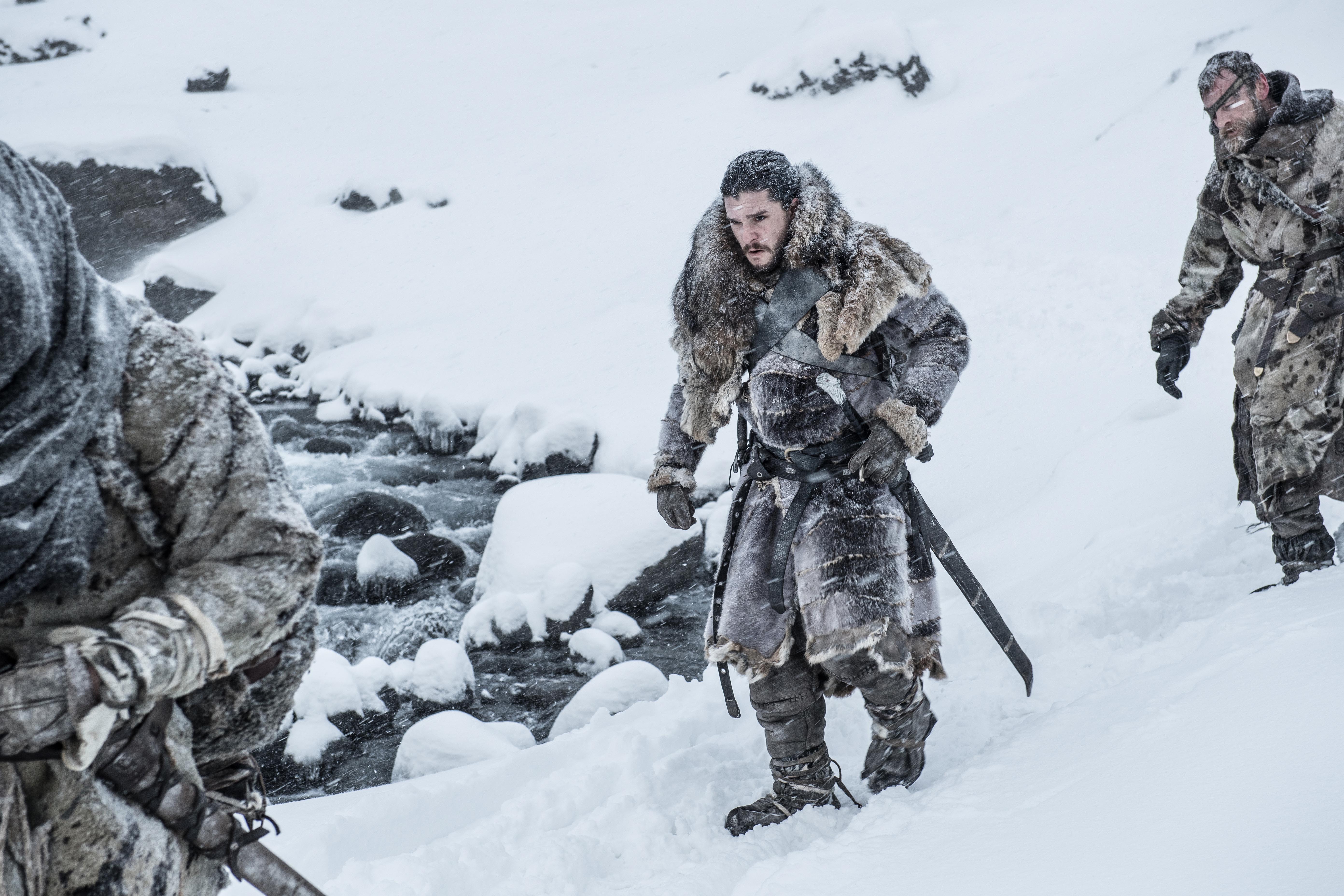 Jon Snow and companions in snowy landscape HD Wallpaper