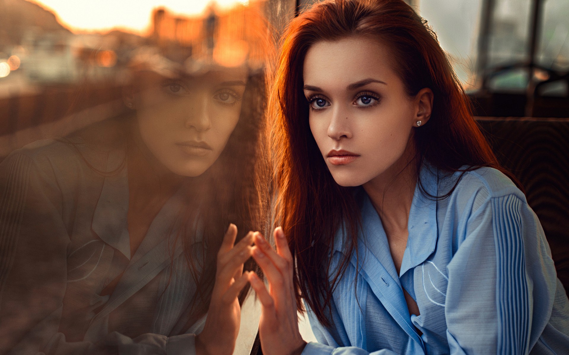Woman looking at her reflection in a window HD Wallpaper