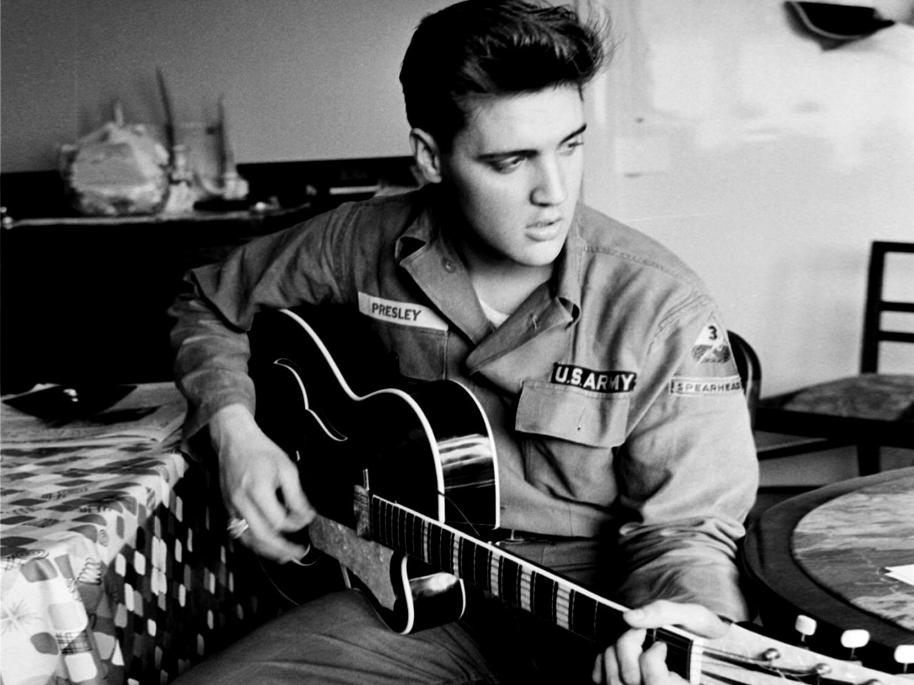 Elvis Presley playing guitar in U.S. Army uniform HD Wallpaper