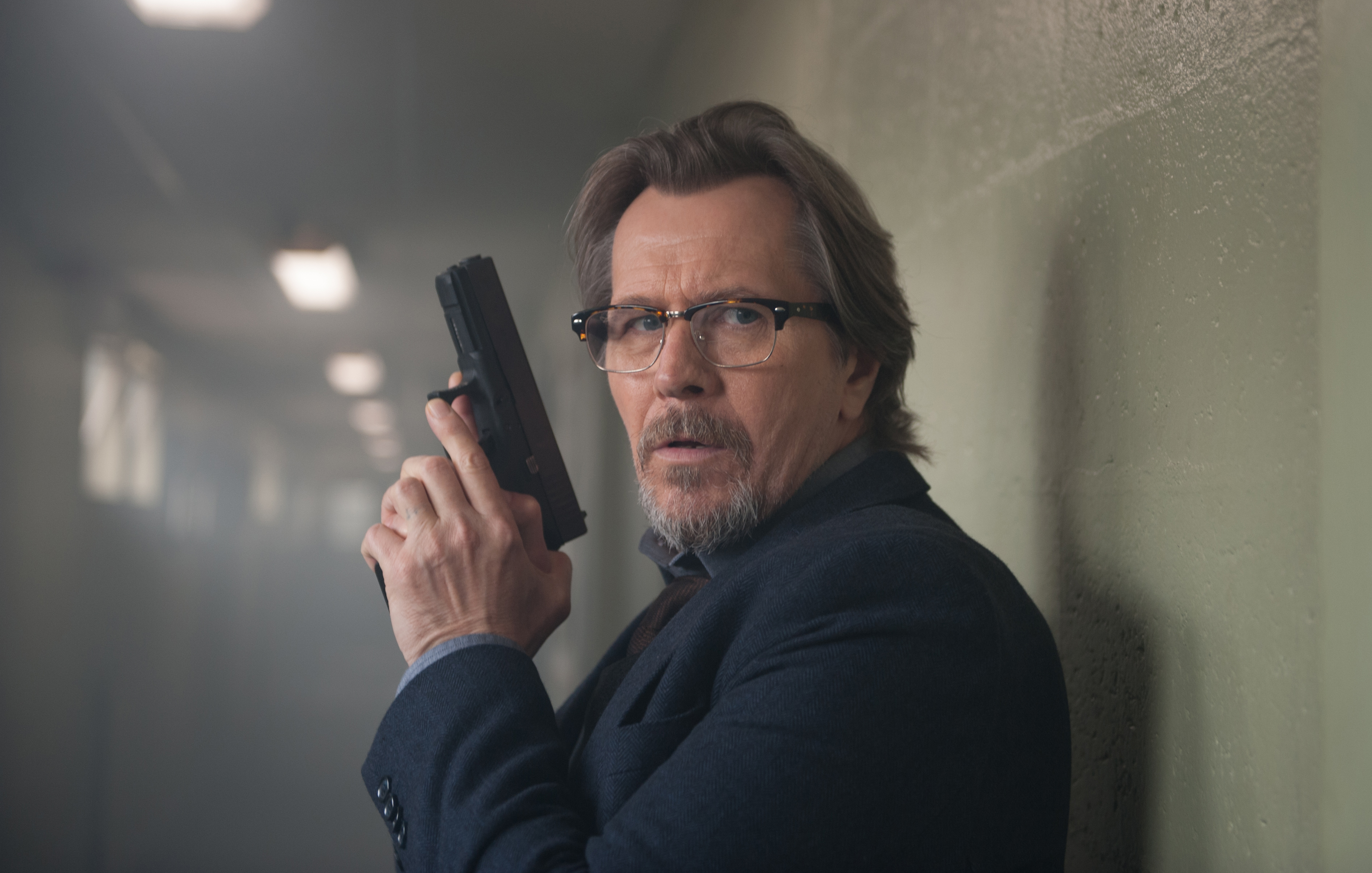 Gary Oldman holding a gun HD Wallpaper