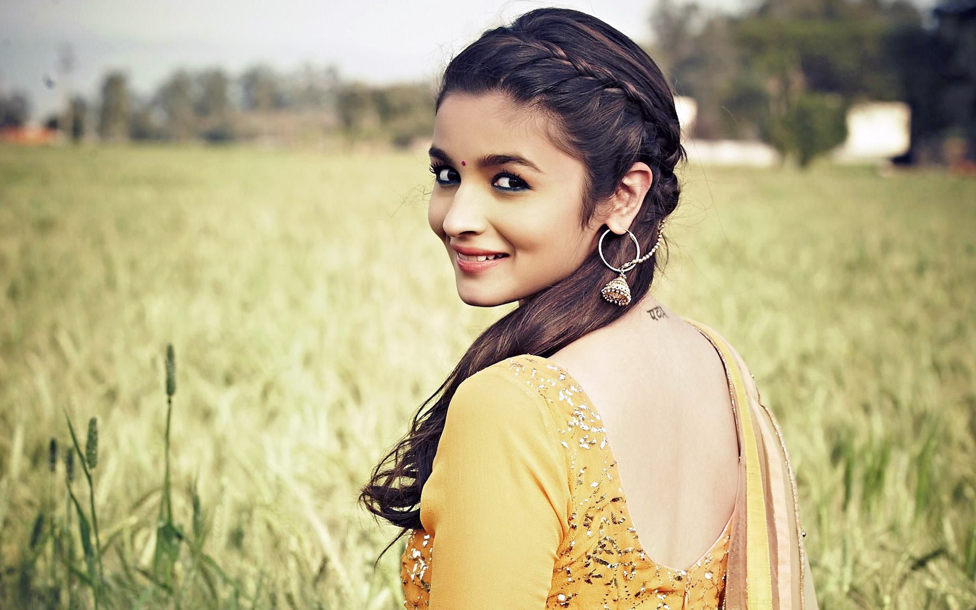 Alia Bhatt in a yellow outfit in a field HD Wallpaper
