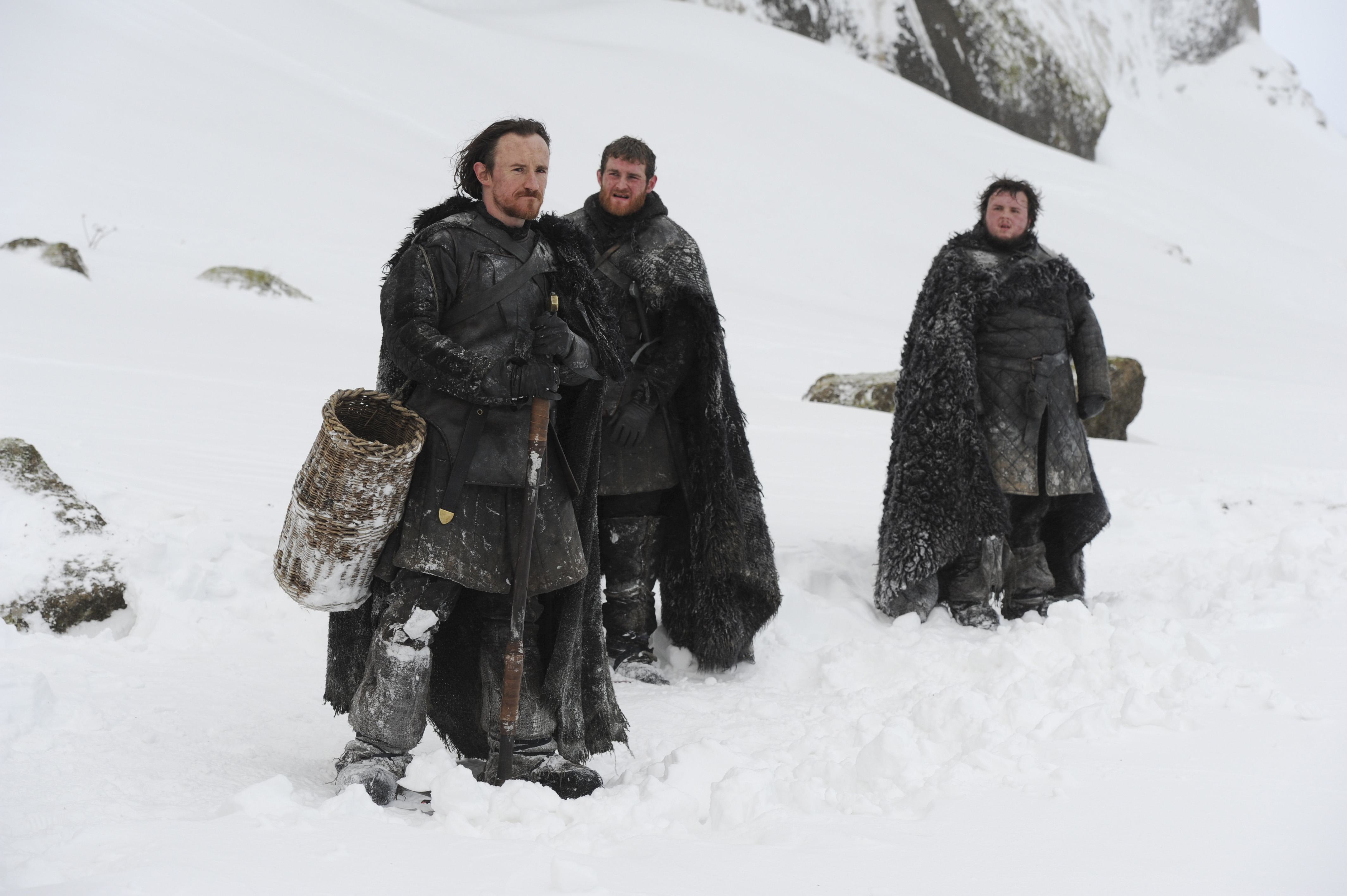 Three men in snow with fur cloaks HD Wallpaper