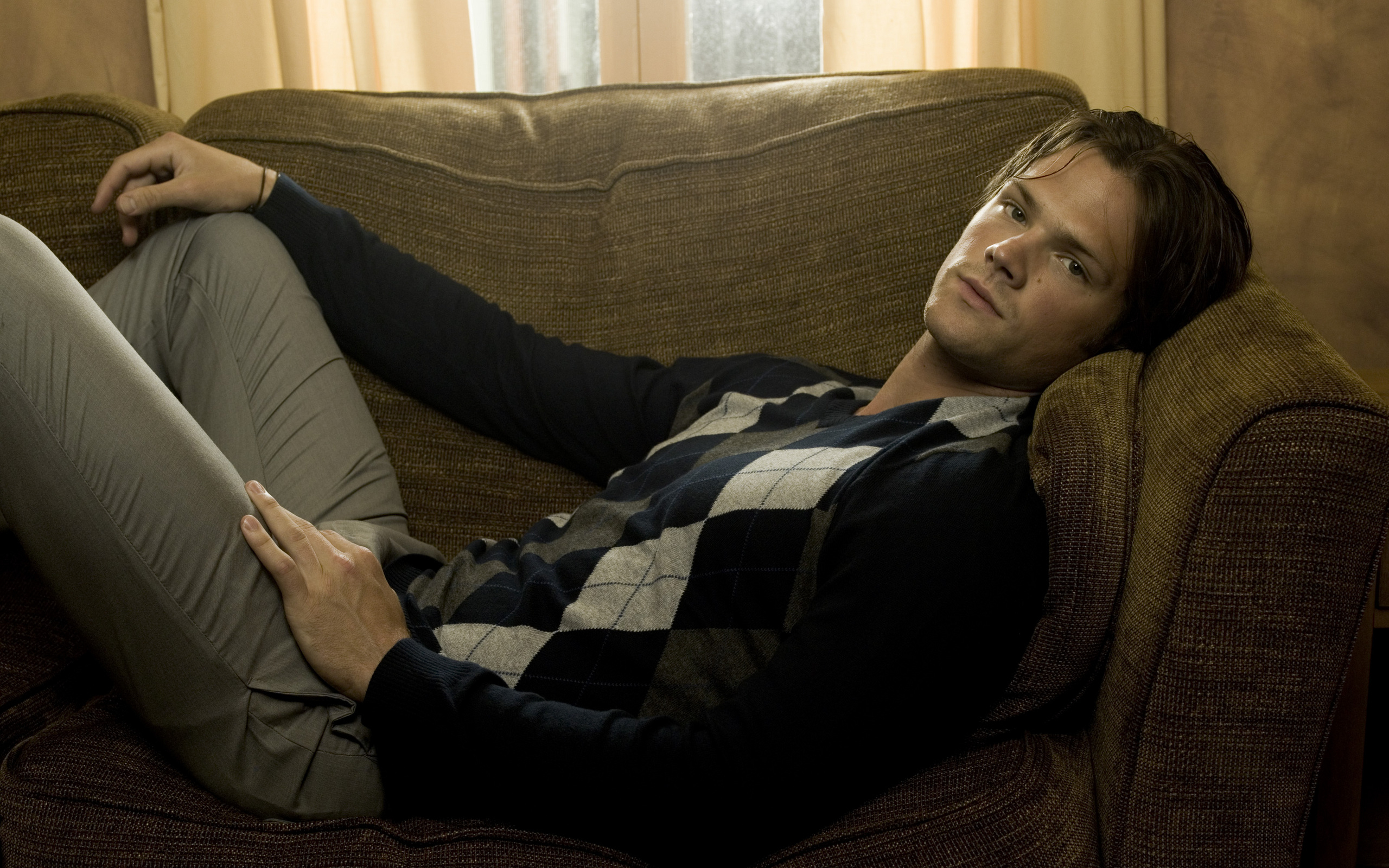 Jared Padalecki relaxing on a couch HD Wallpaper