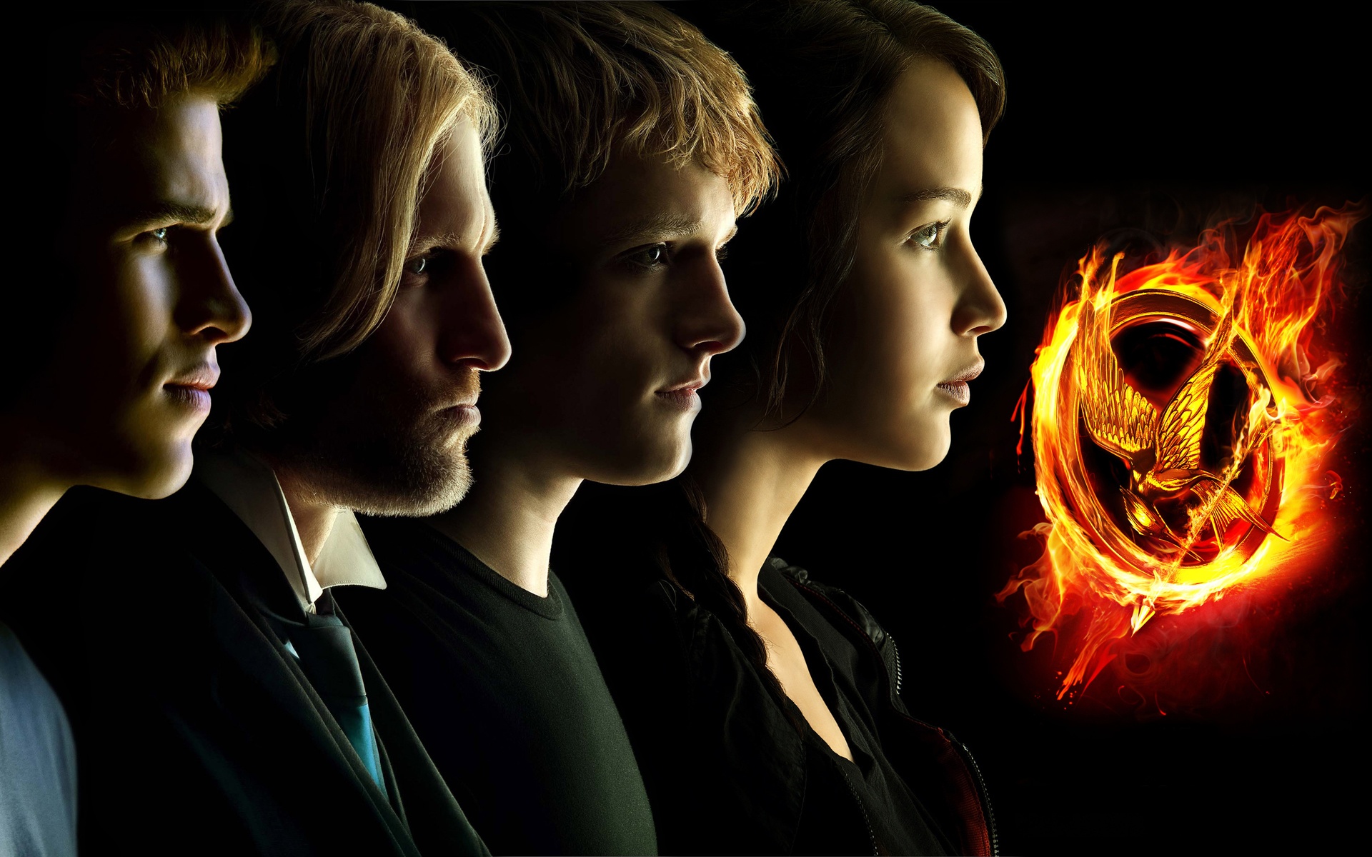 The Hunger Games characters with flaming Mockingjay symbol HD Wallpaper