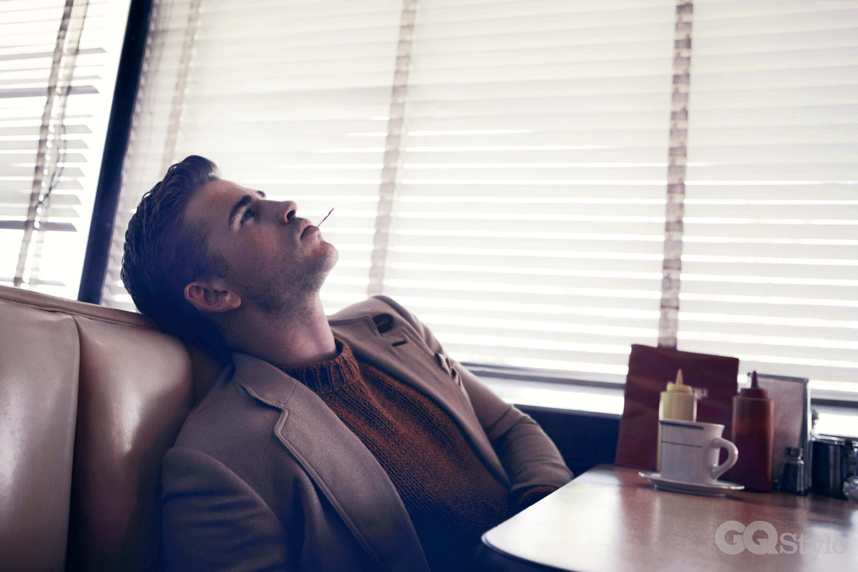 Liam Hemsworth in a diner booth HD Wallpaper