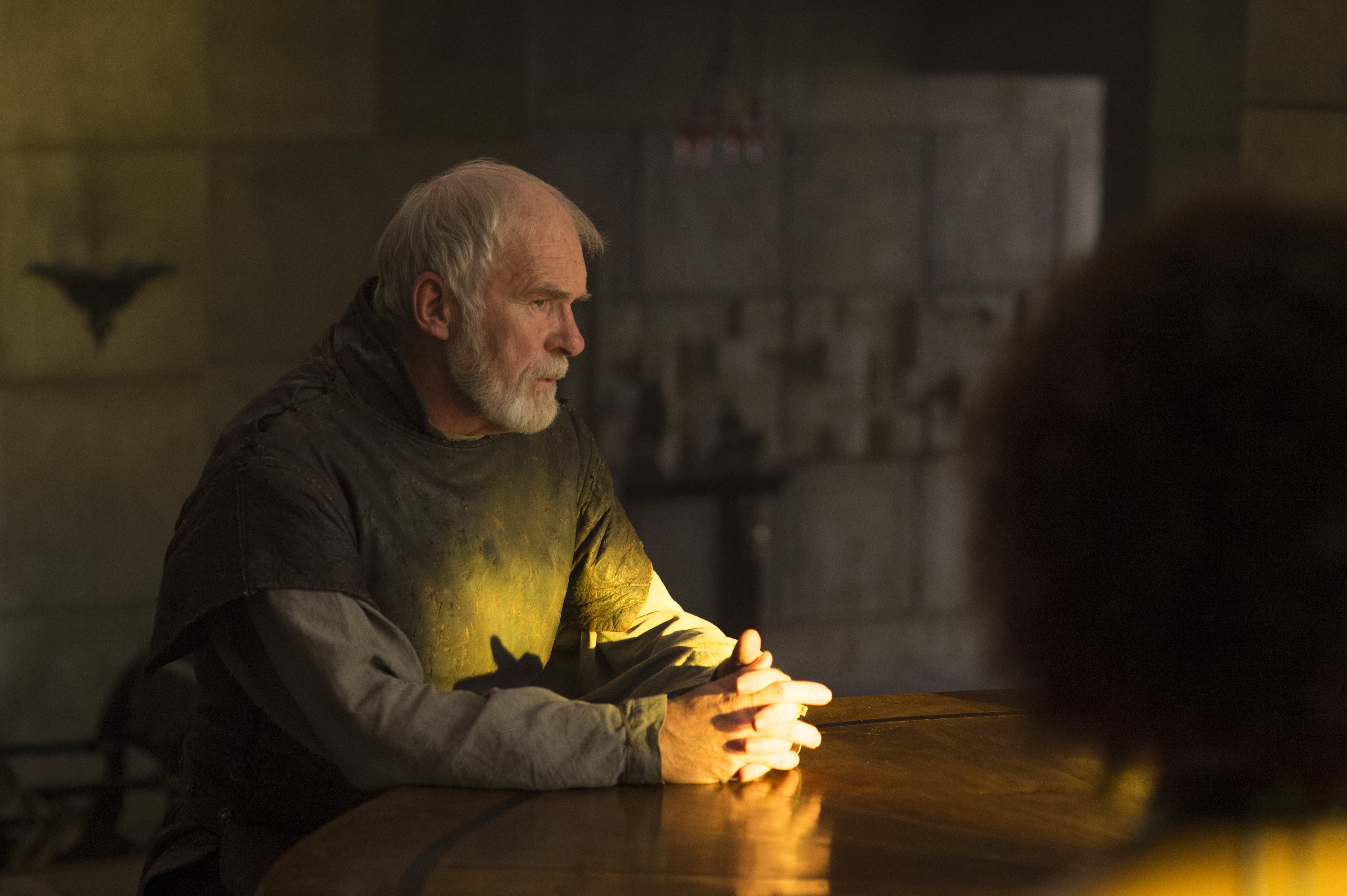 Ian McElhinney sitting at a table HD Wallpaper