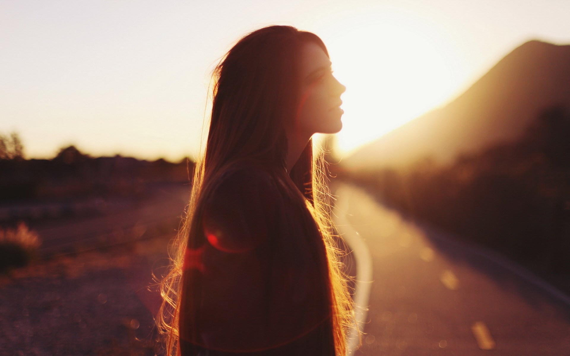 Woman in silhouette against a sunset HD Wallpaper