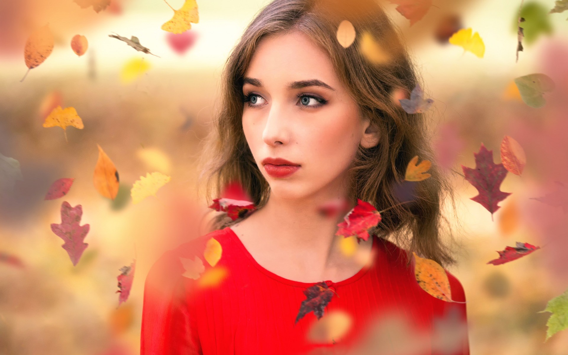 Woman in red dress with falling autumn leaves HD Wallpaper