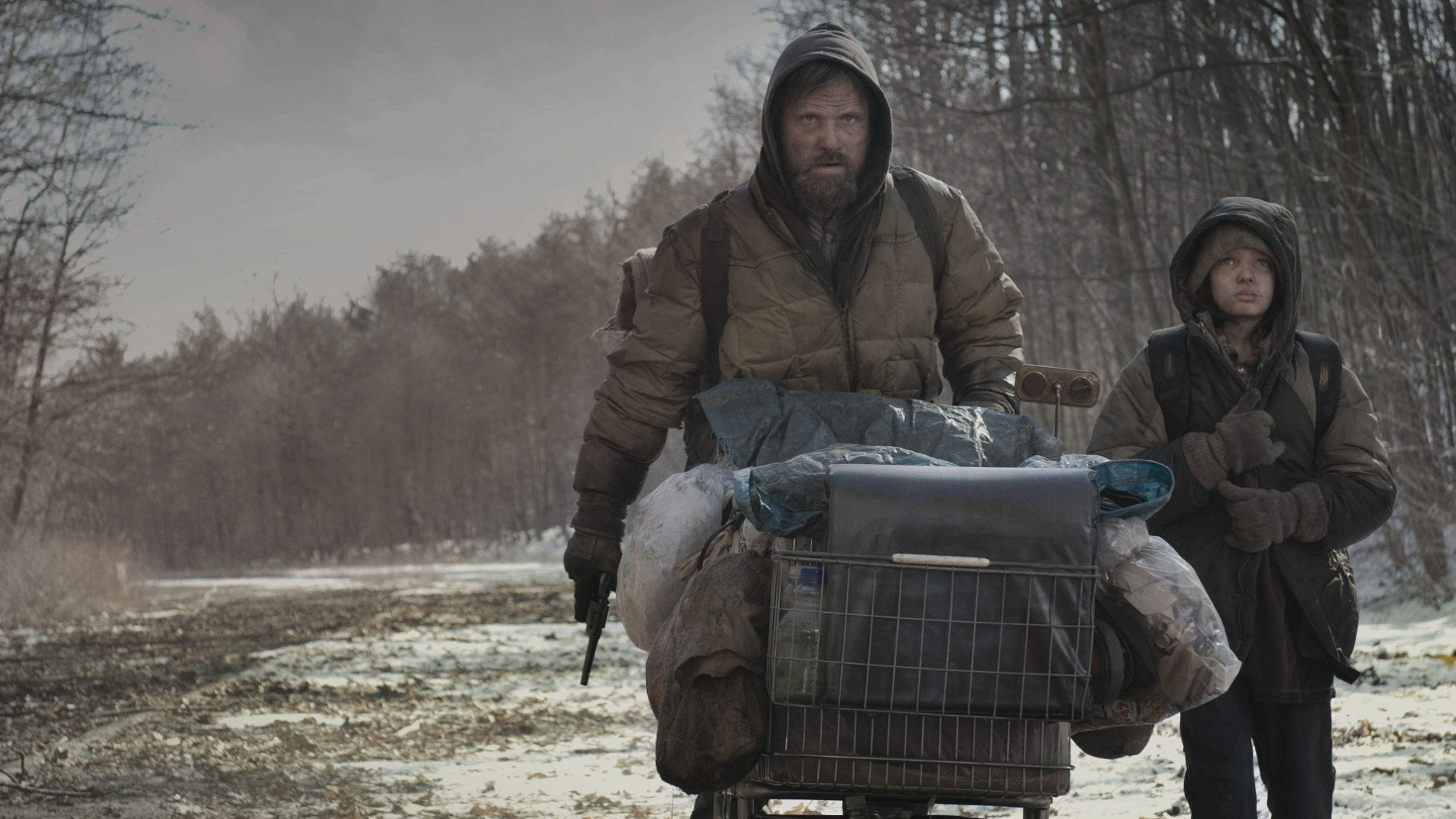 Man and boy with cart in post-apocalyptic setting HD Wallpaper