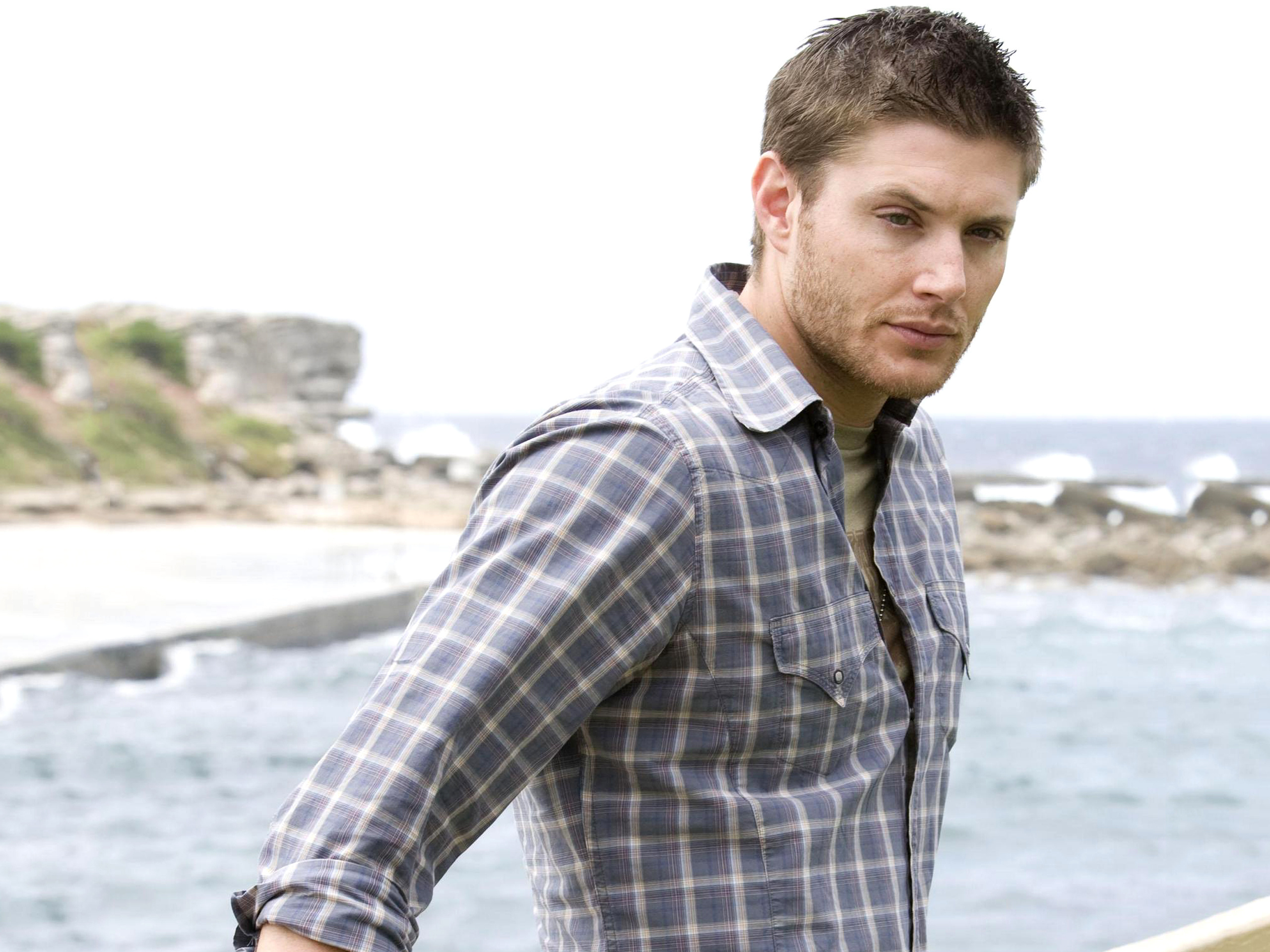 Jensen Ackles on a rocky coastline HD Wallpaper