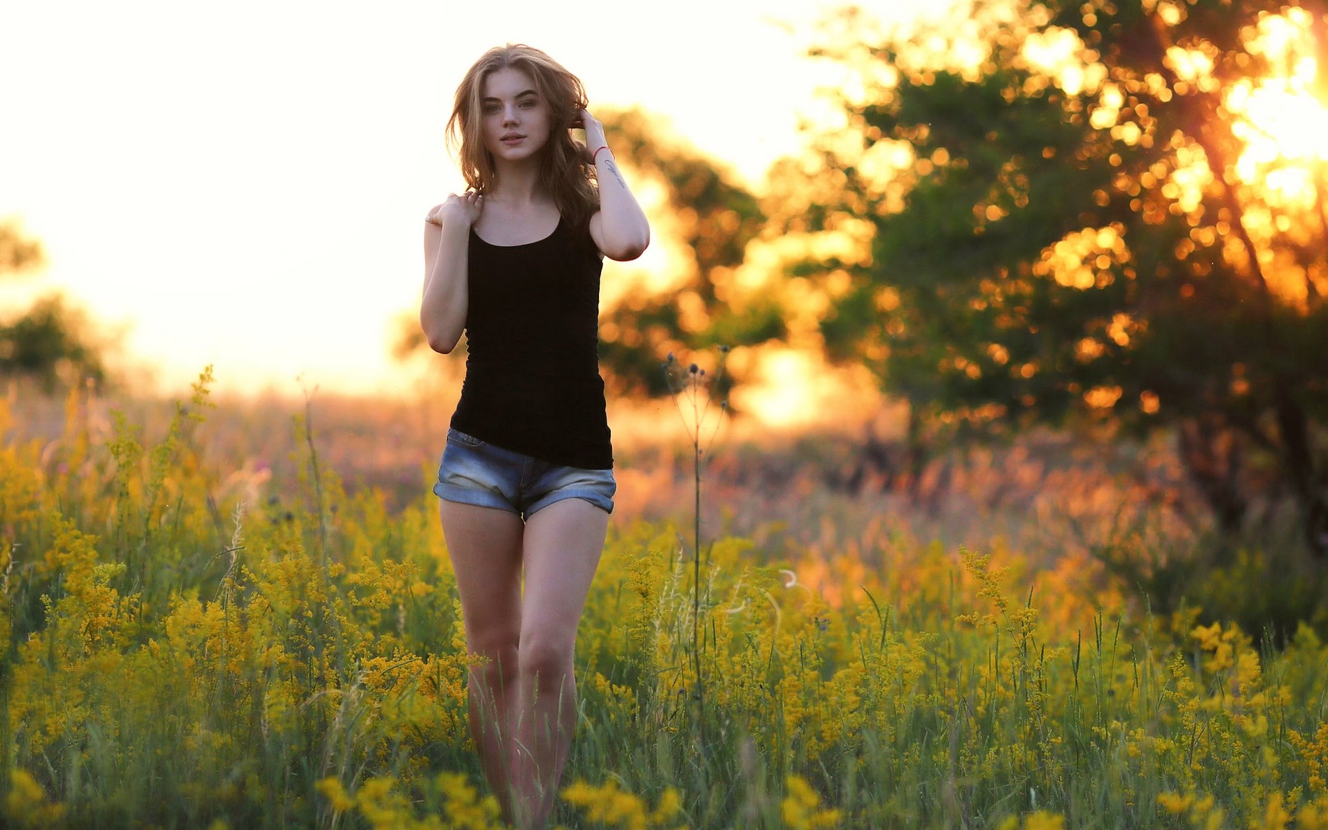 Woman in black tank top and denim shorts in a field HD Wallpaper