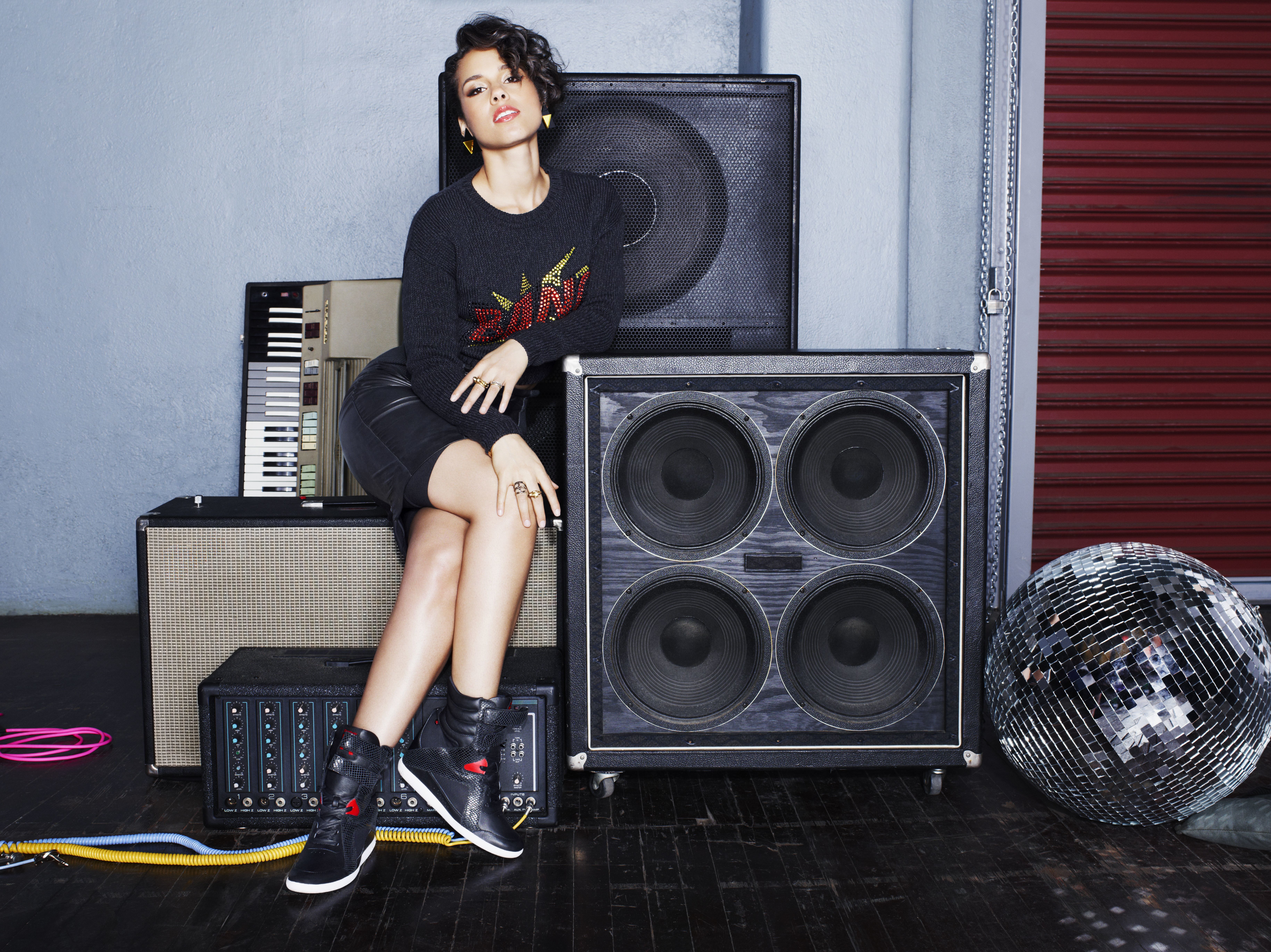 Alicia Keys sitting on speakers HD Wallpaper