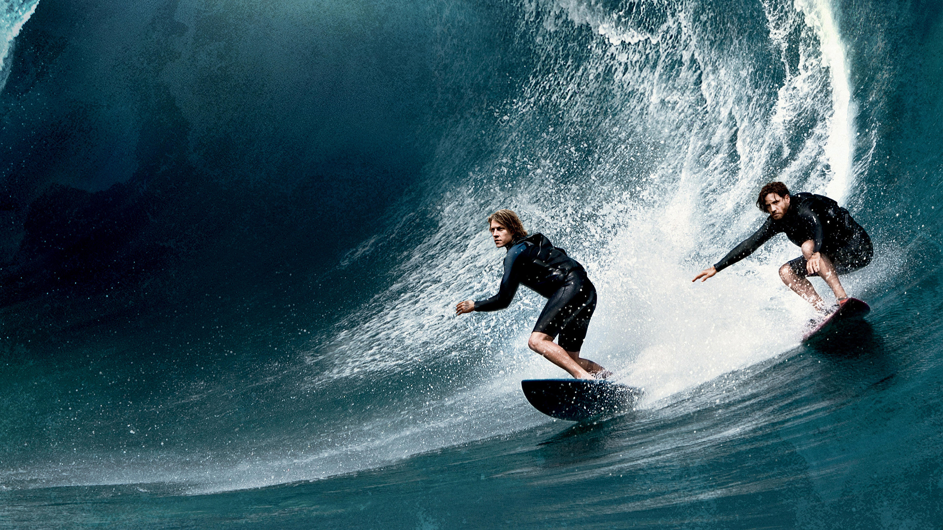 Two surfers riding a wave HD Wallpaper