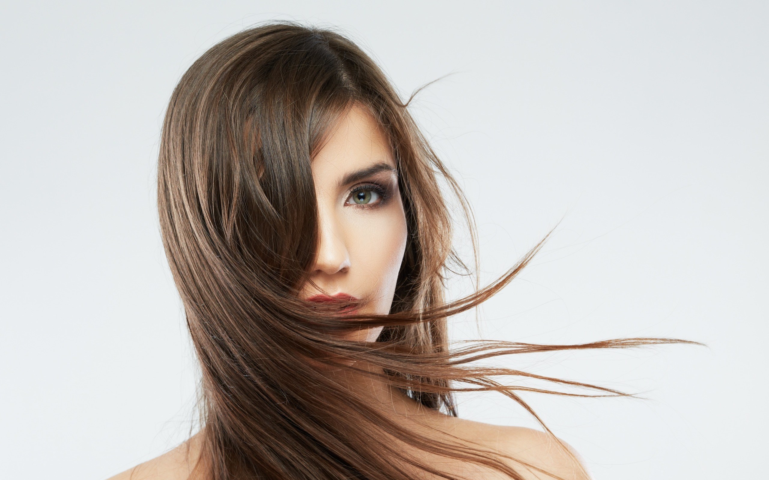 Woman with long brown hair blowing in the wind HD Wallpaper