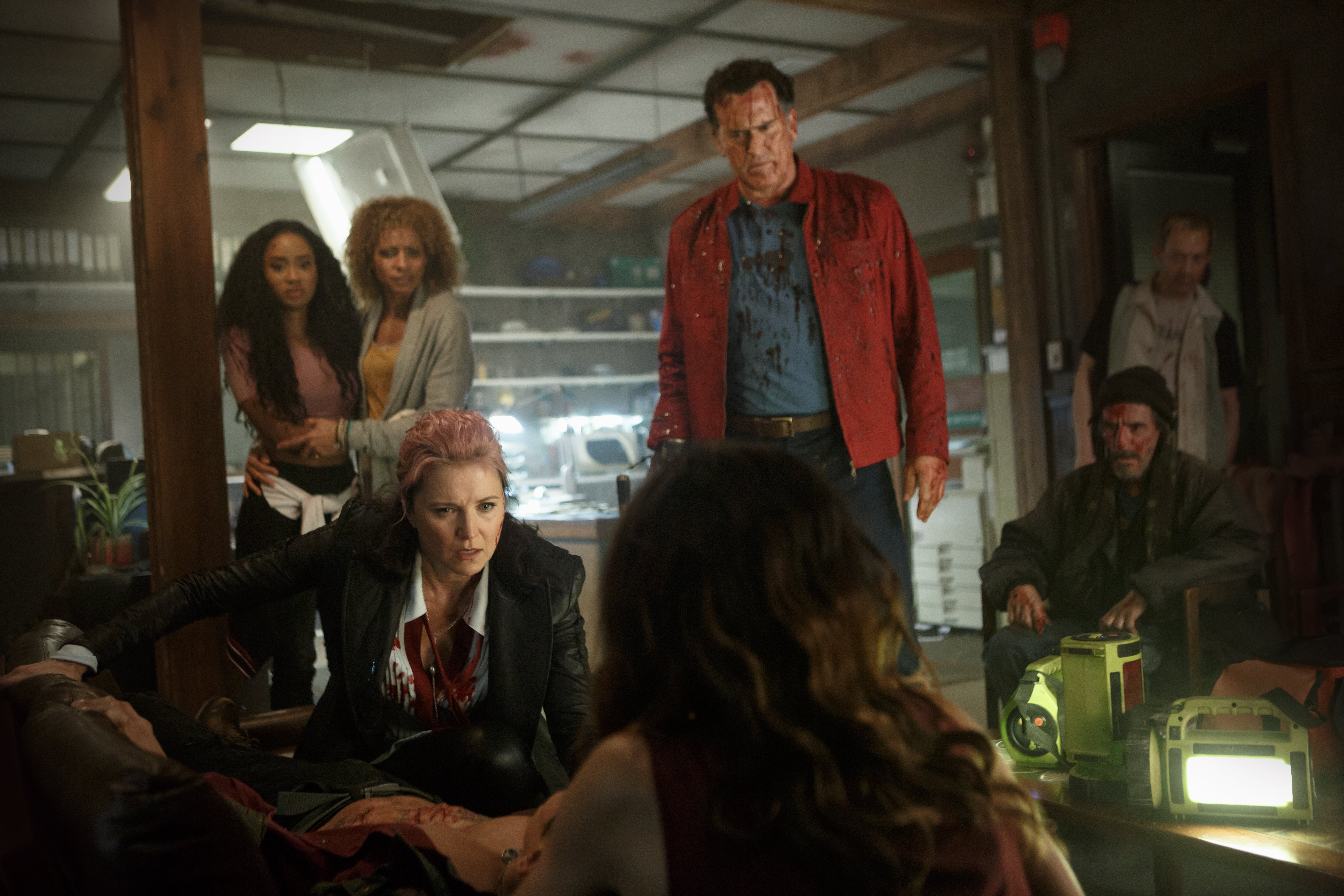 Bruce Campbell and group in a tense scene HD Wallpaper