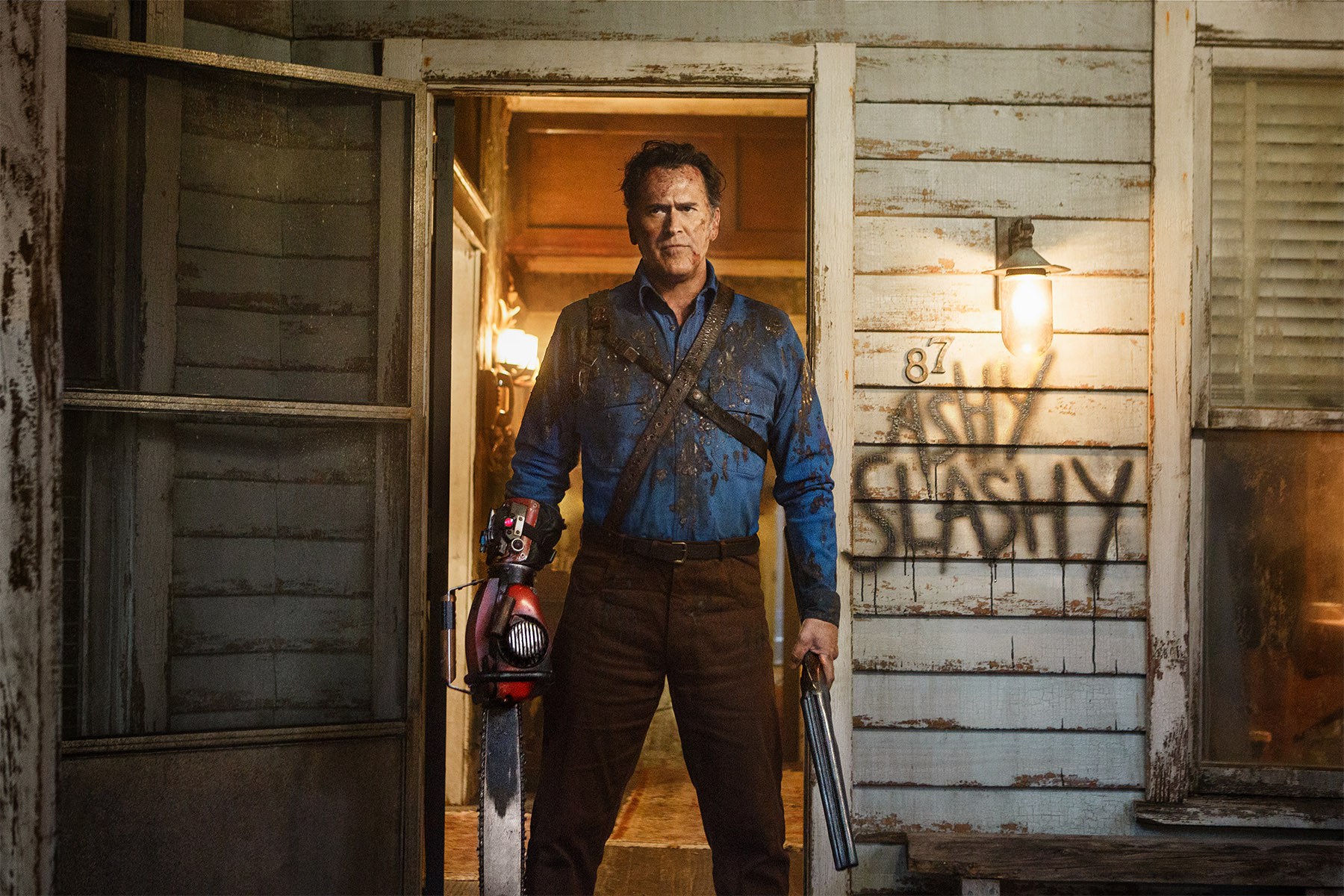 Ash Williams from Evil Dead with chainsaw and shotgun HD Wallpaper
