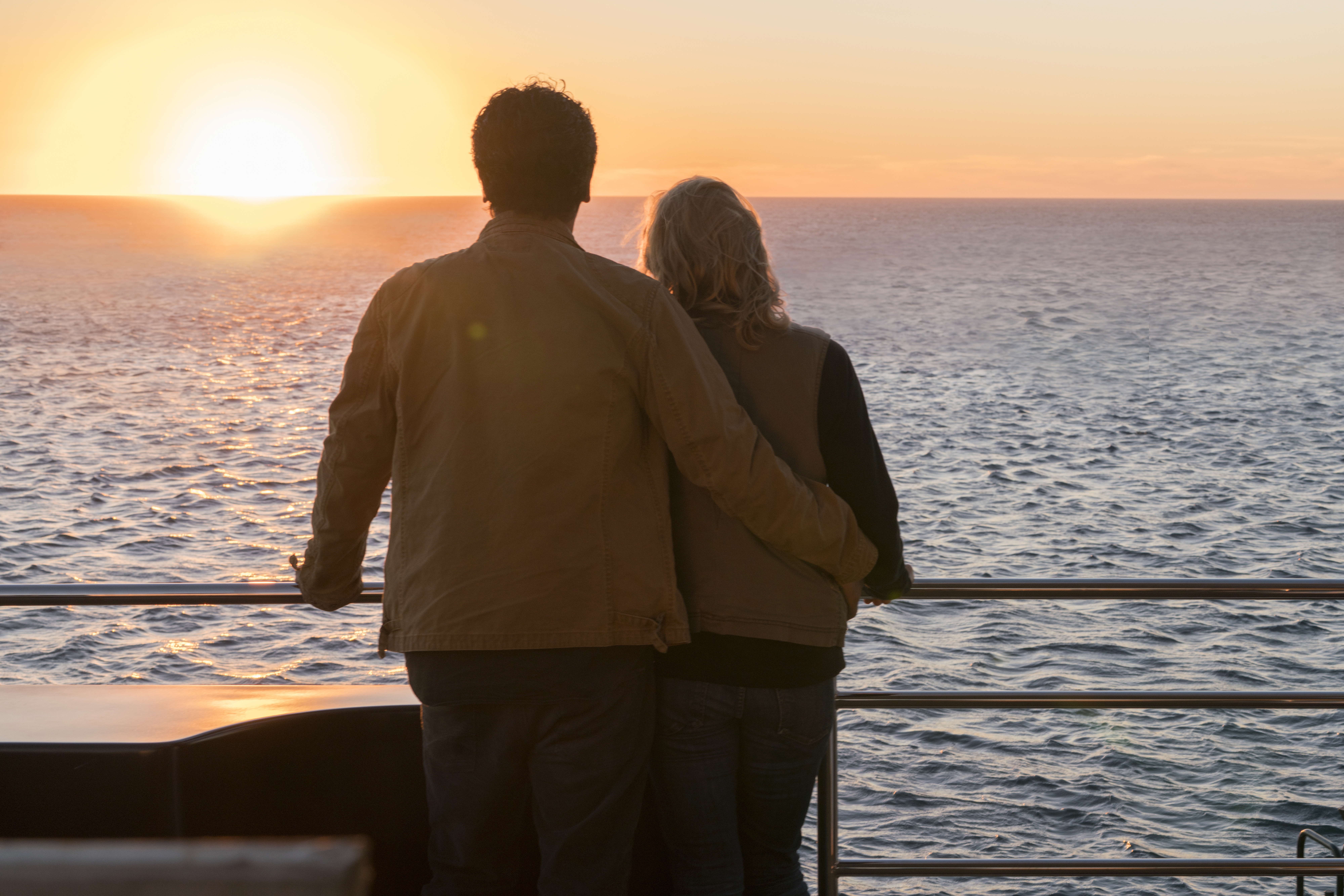 Kim Dickens on a boat at sunset HD Wallpaper