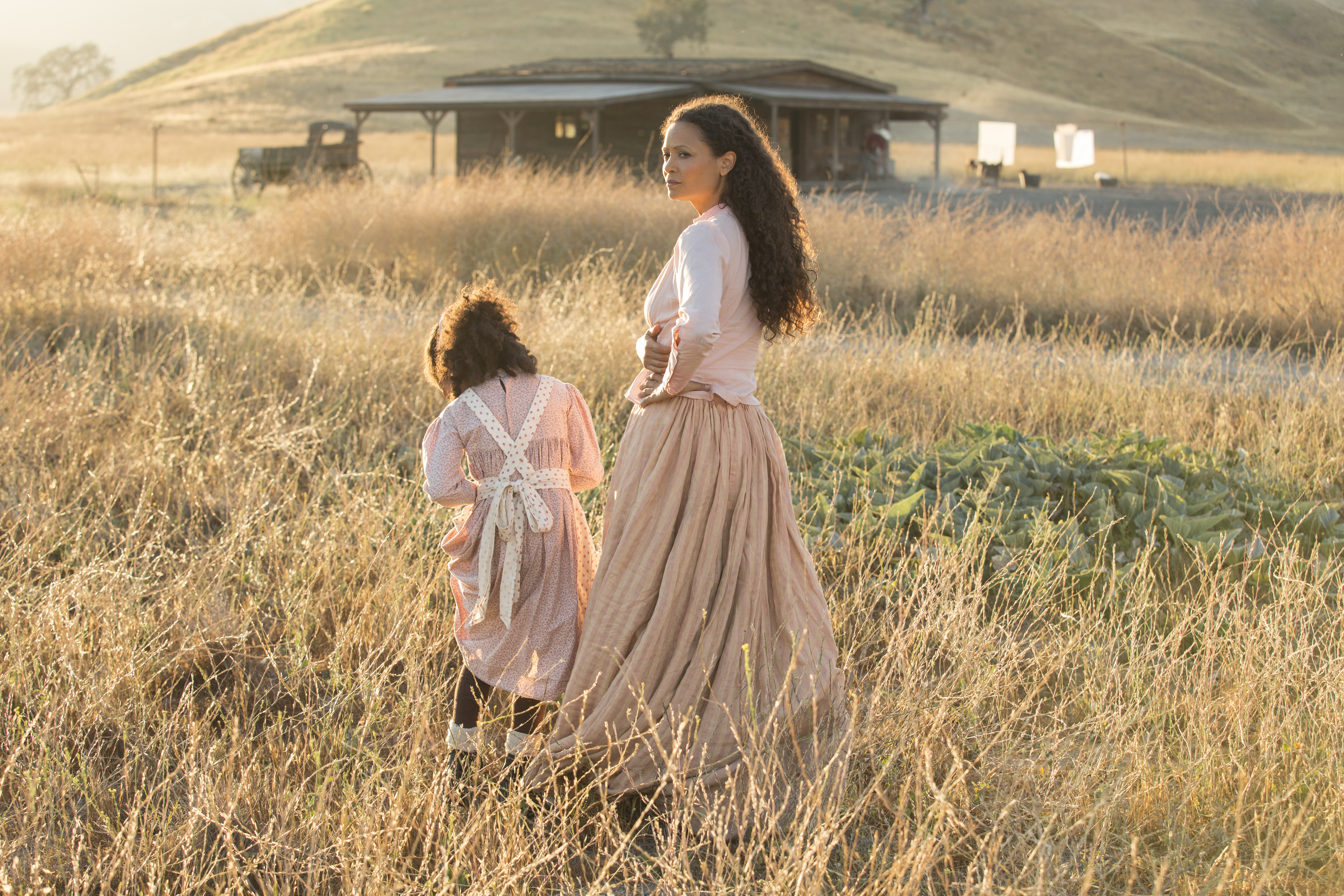 Thandie Newton and child in a field HD Wallpaper
