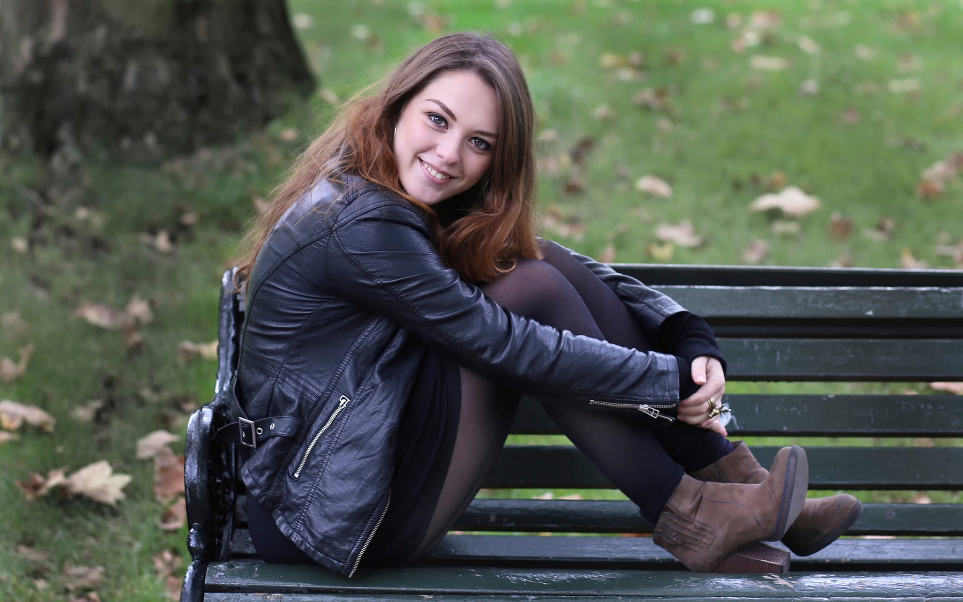 Woman sitting on a park bench HD Wallpaper