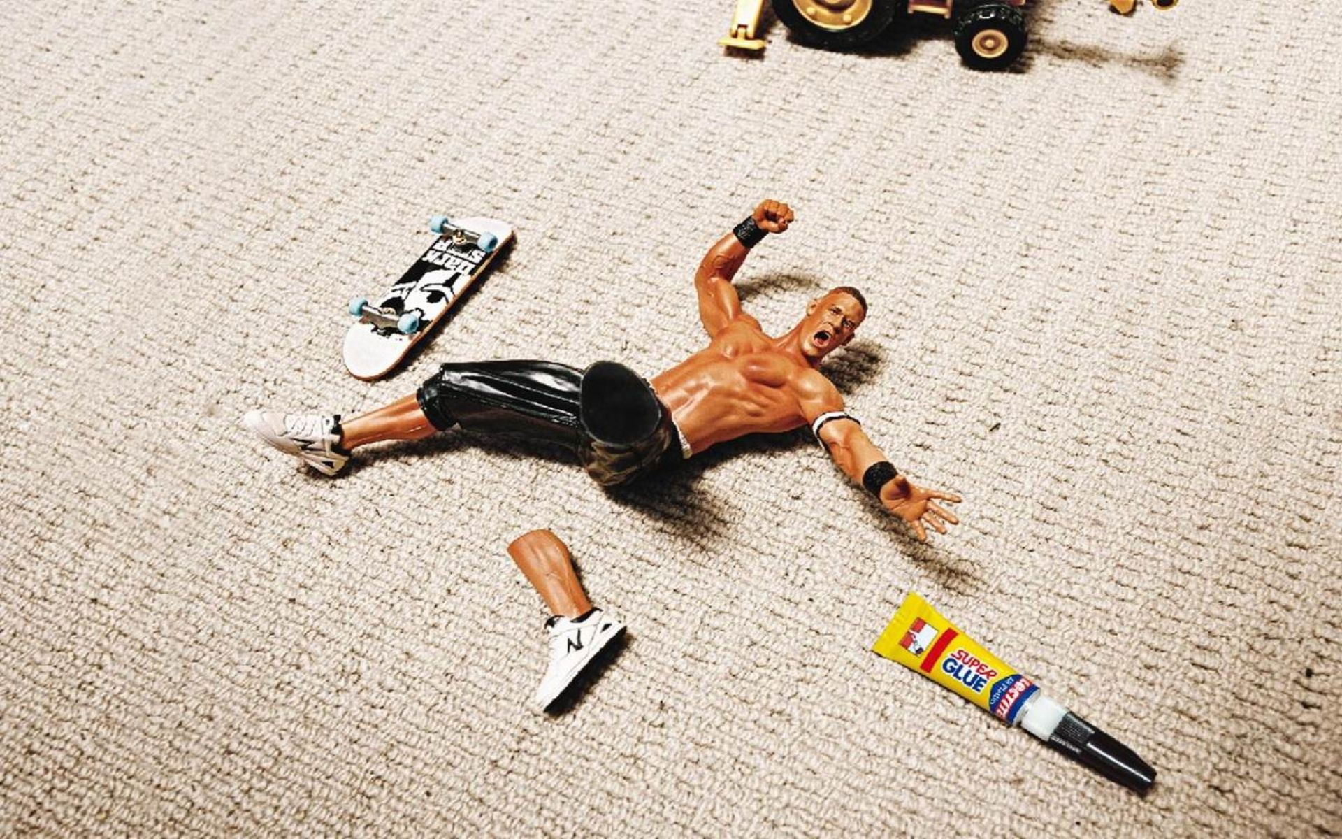John Cena action figure with broken leg and skateboard HD Wallpaper