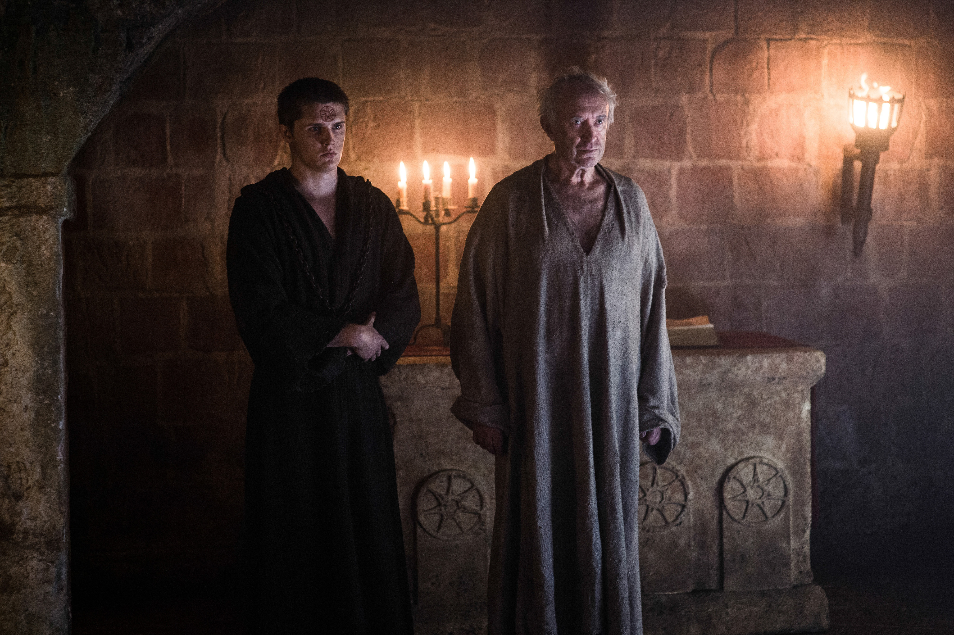 Jonathan Pryce and a young man in a dark room HD Wallpaper