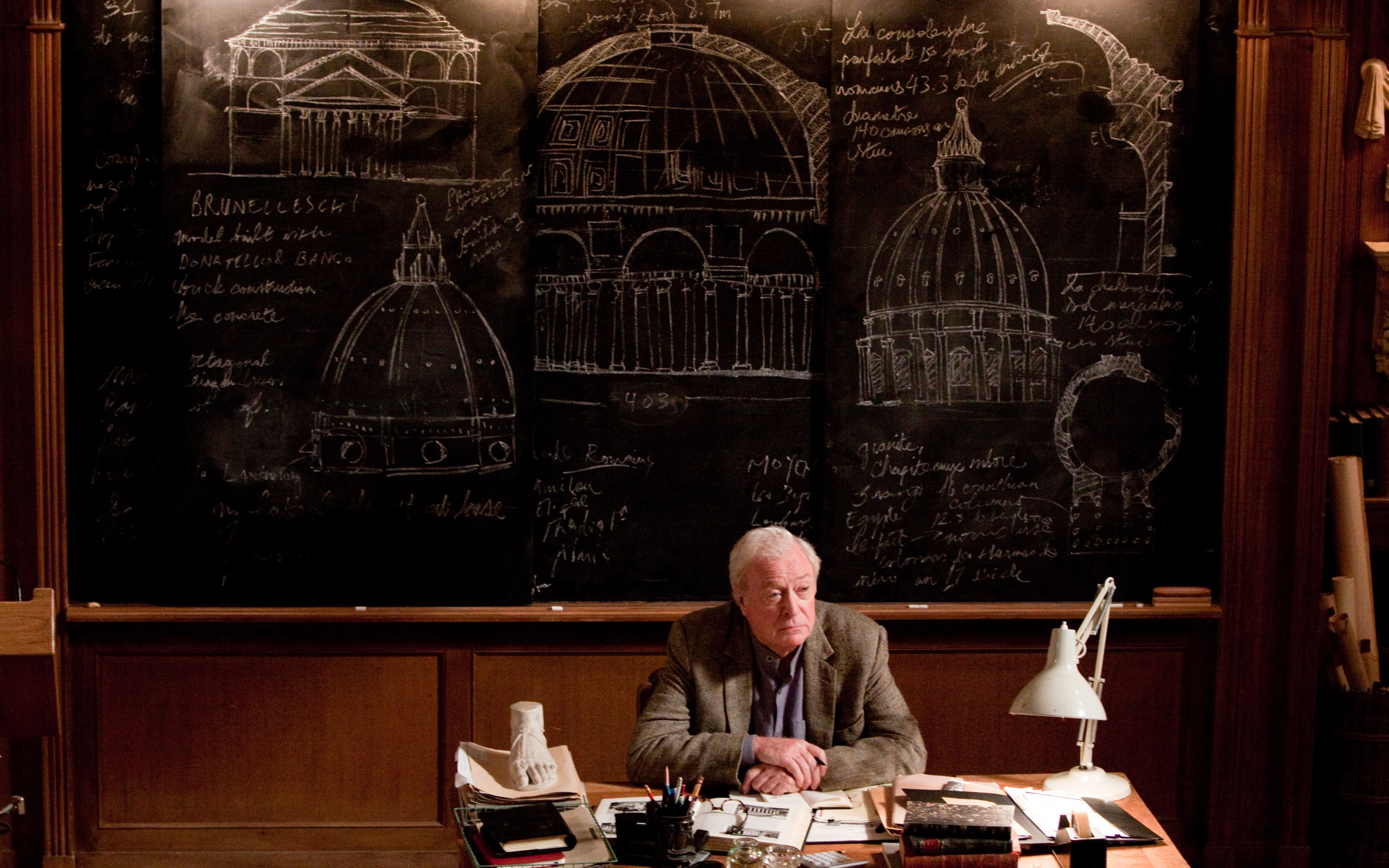 Michael Caine in front of architectural drawings HD Wallpaper