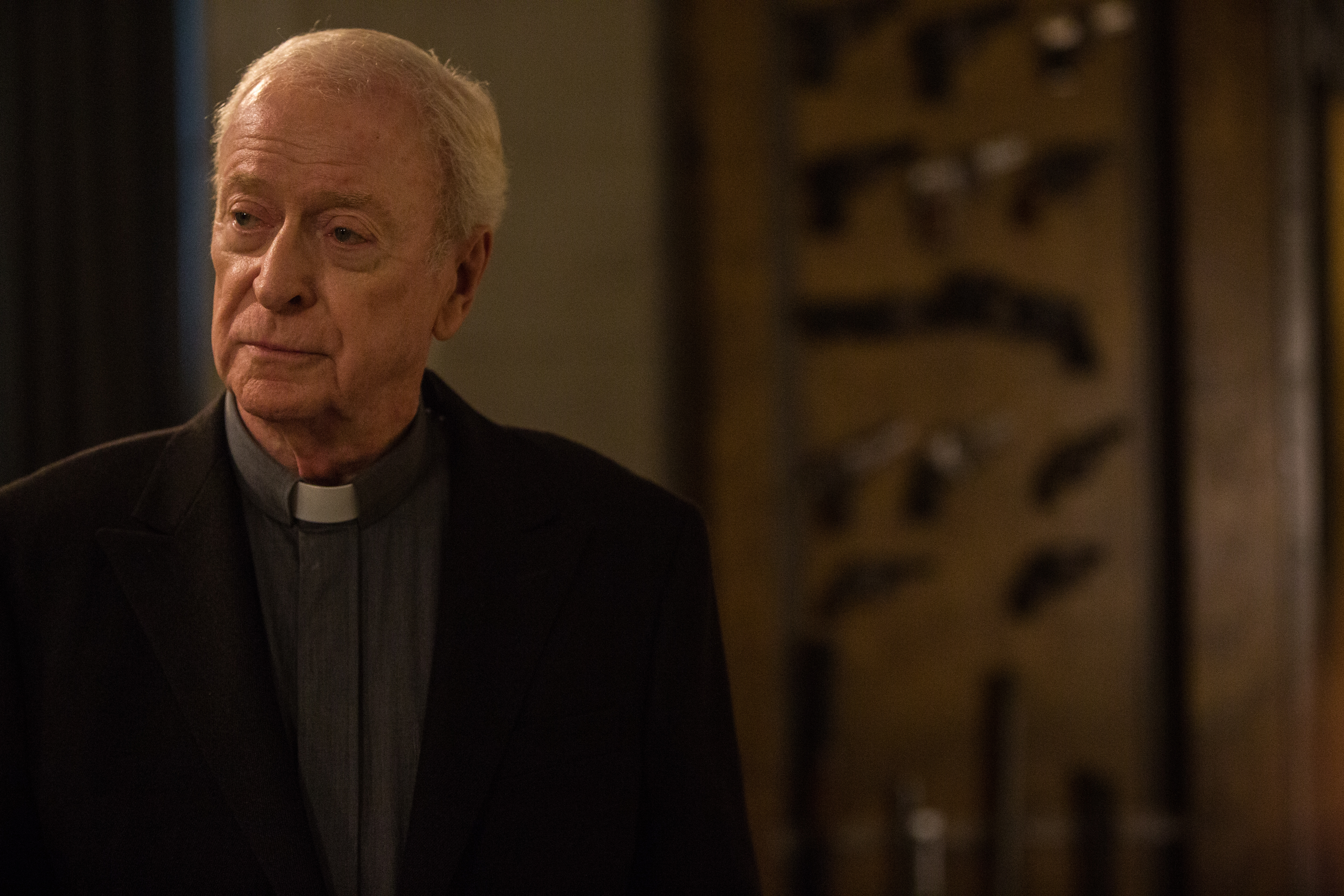 Michael Caine in a priest's collar HD Wallpaper