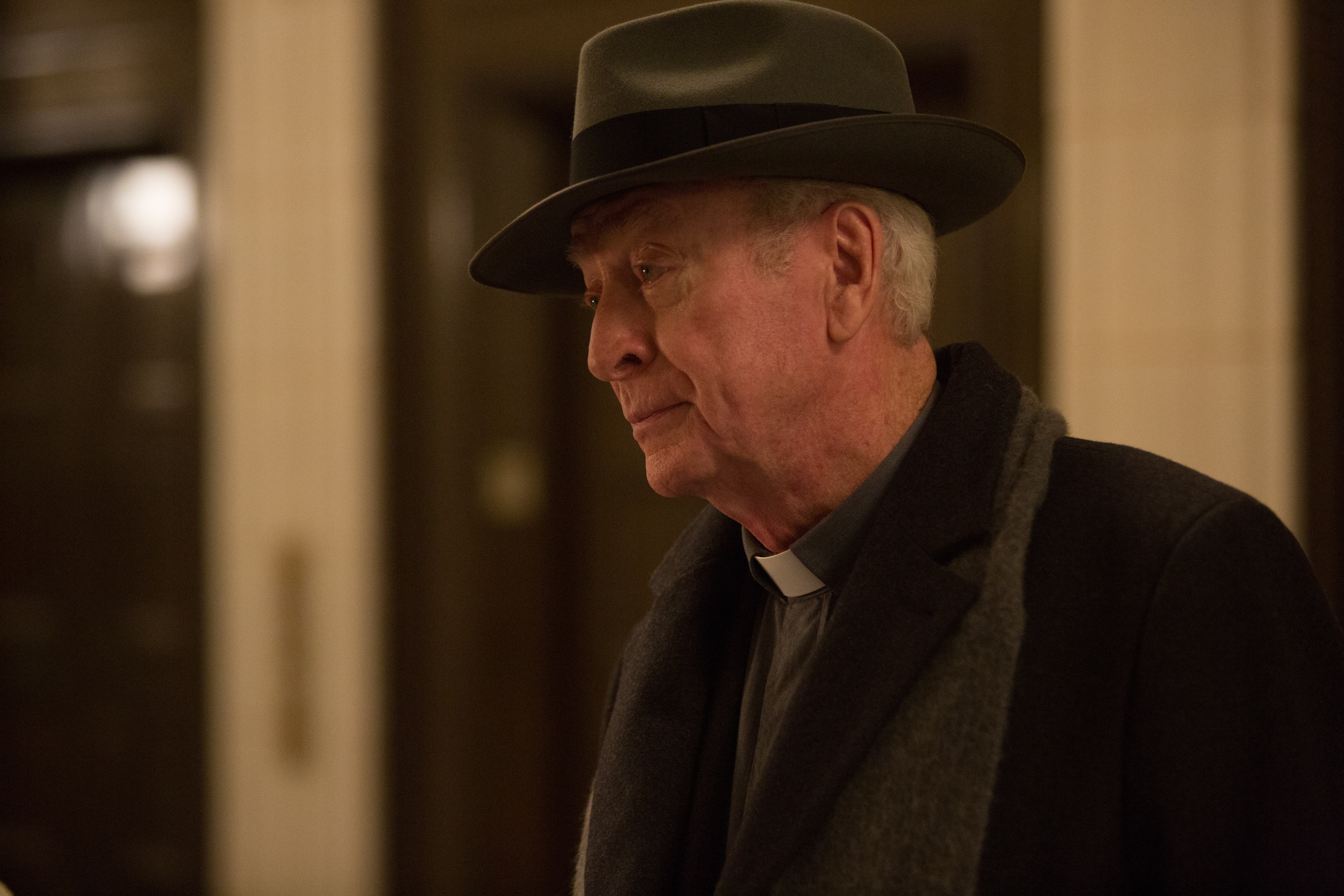Michael Caine wearing a hat and clerical collar HD Wallpaper