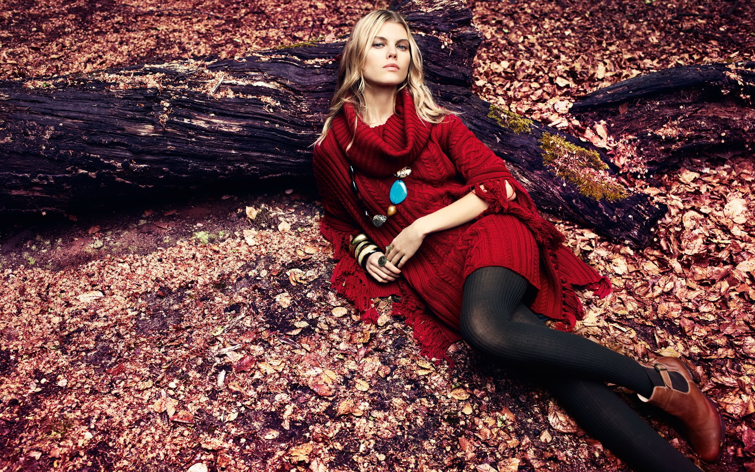 Maryna Linchuk in red sweater lying on logs HD Wallpaper