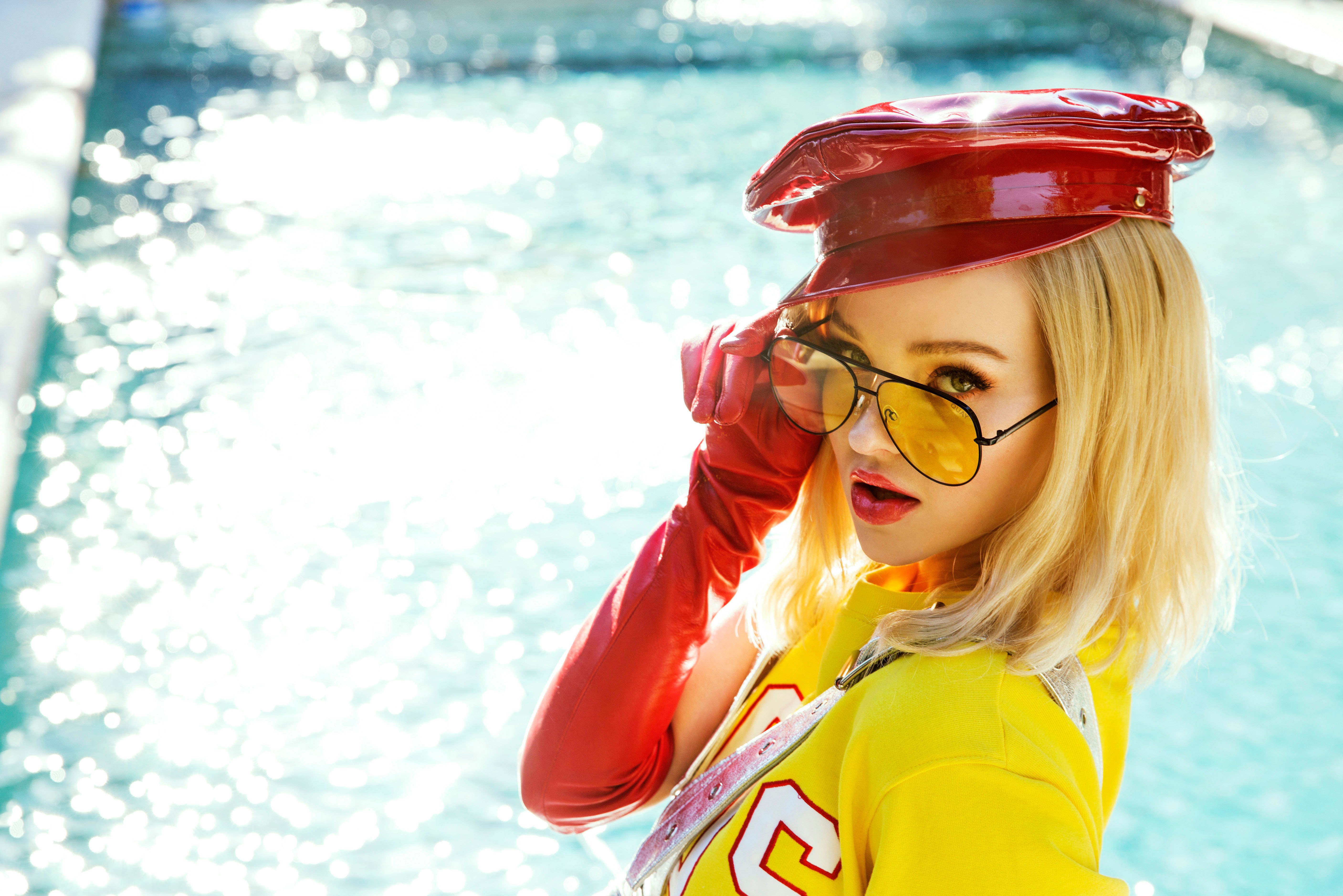 Dove Cameron in red hat and yellow shirt HD Wallpaper