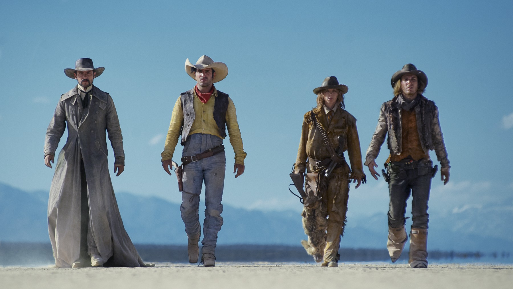 Jean Dujardin and three cowboys walking in desert HD Wallpaper