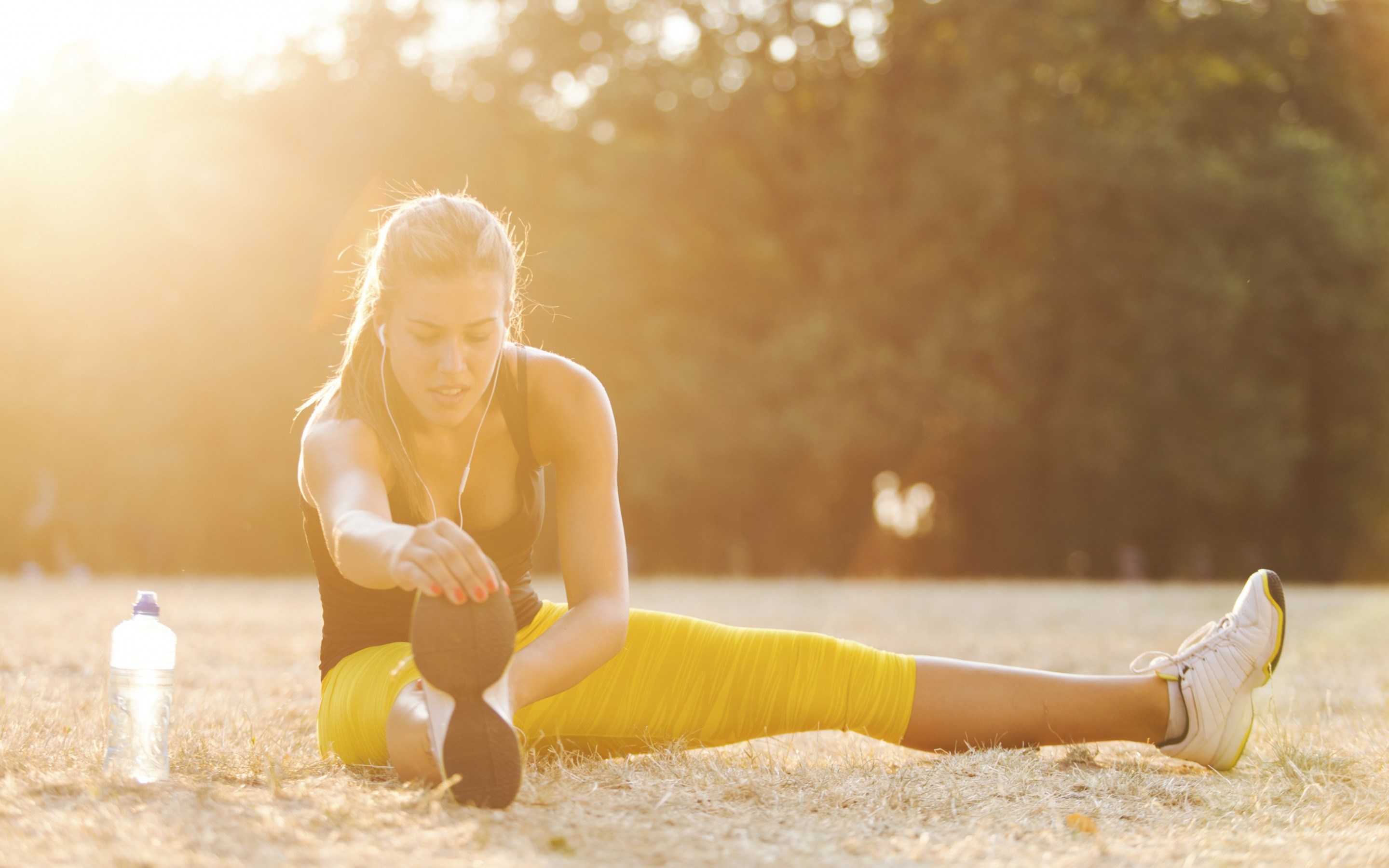 Woman stretching outdoors at sunset HD Wallpaper