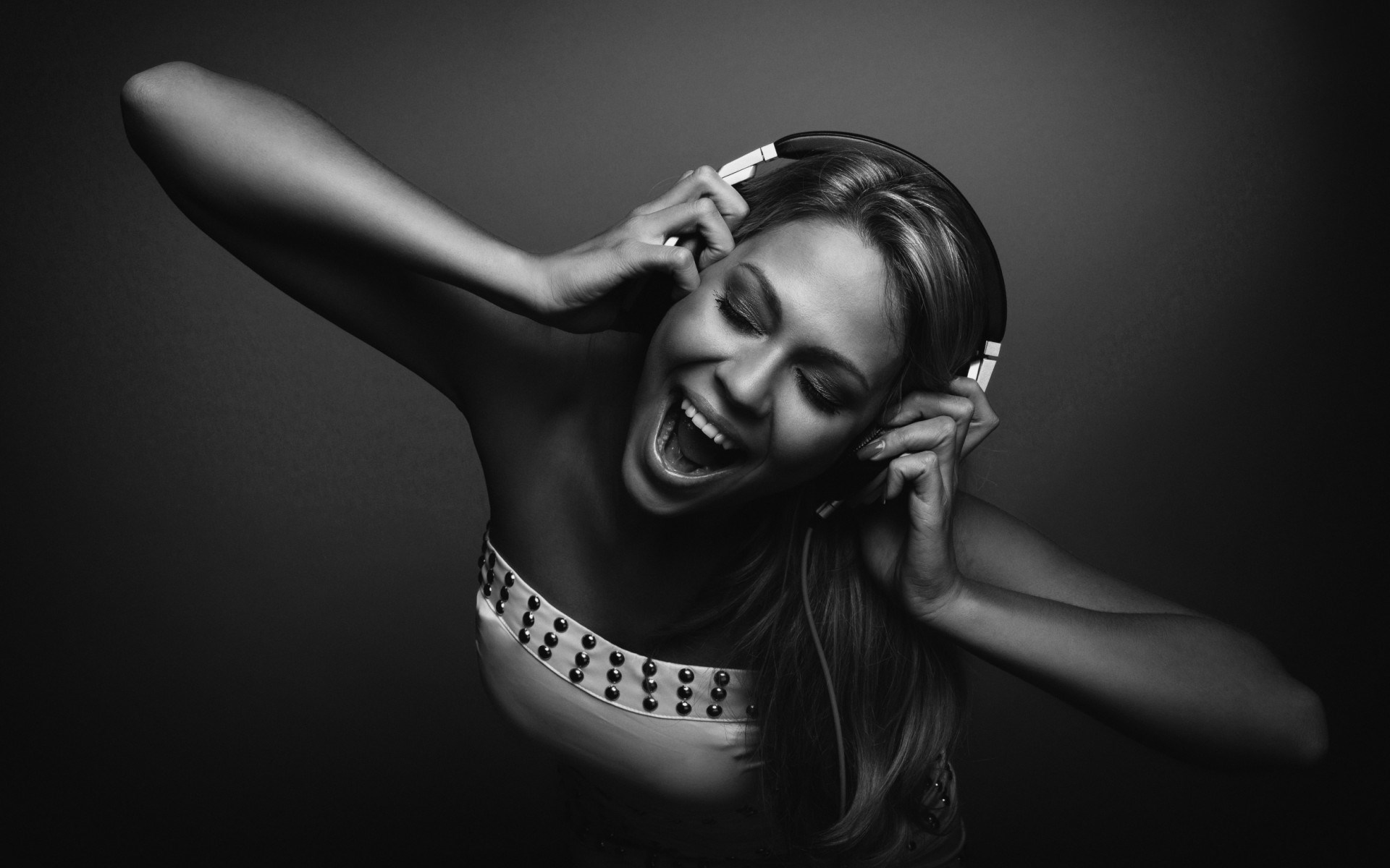 Woman wearing headphones singing HD Wallpaper