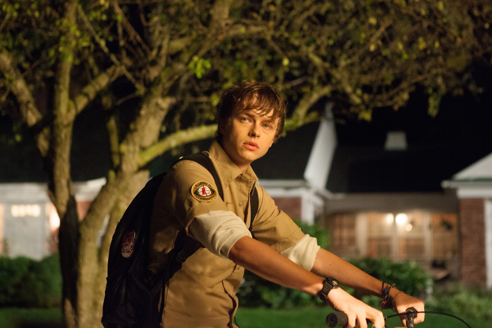 Dane DeHaan on a bicycle at night HD Wallpaper