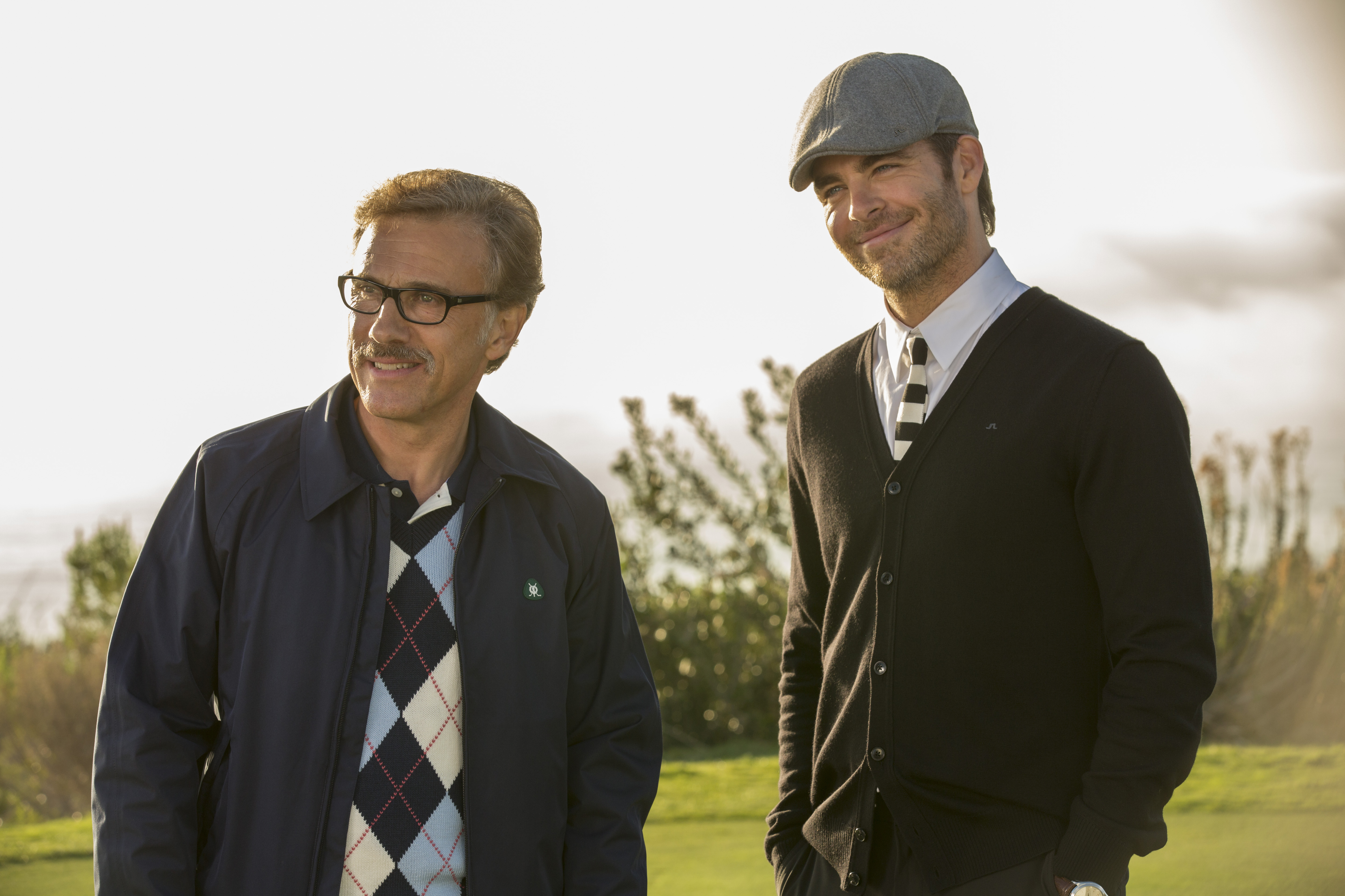 Christoph Waltz and Chris Pine on a golf course HD Wallpaper