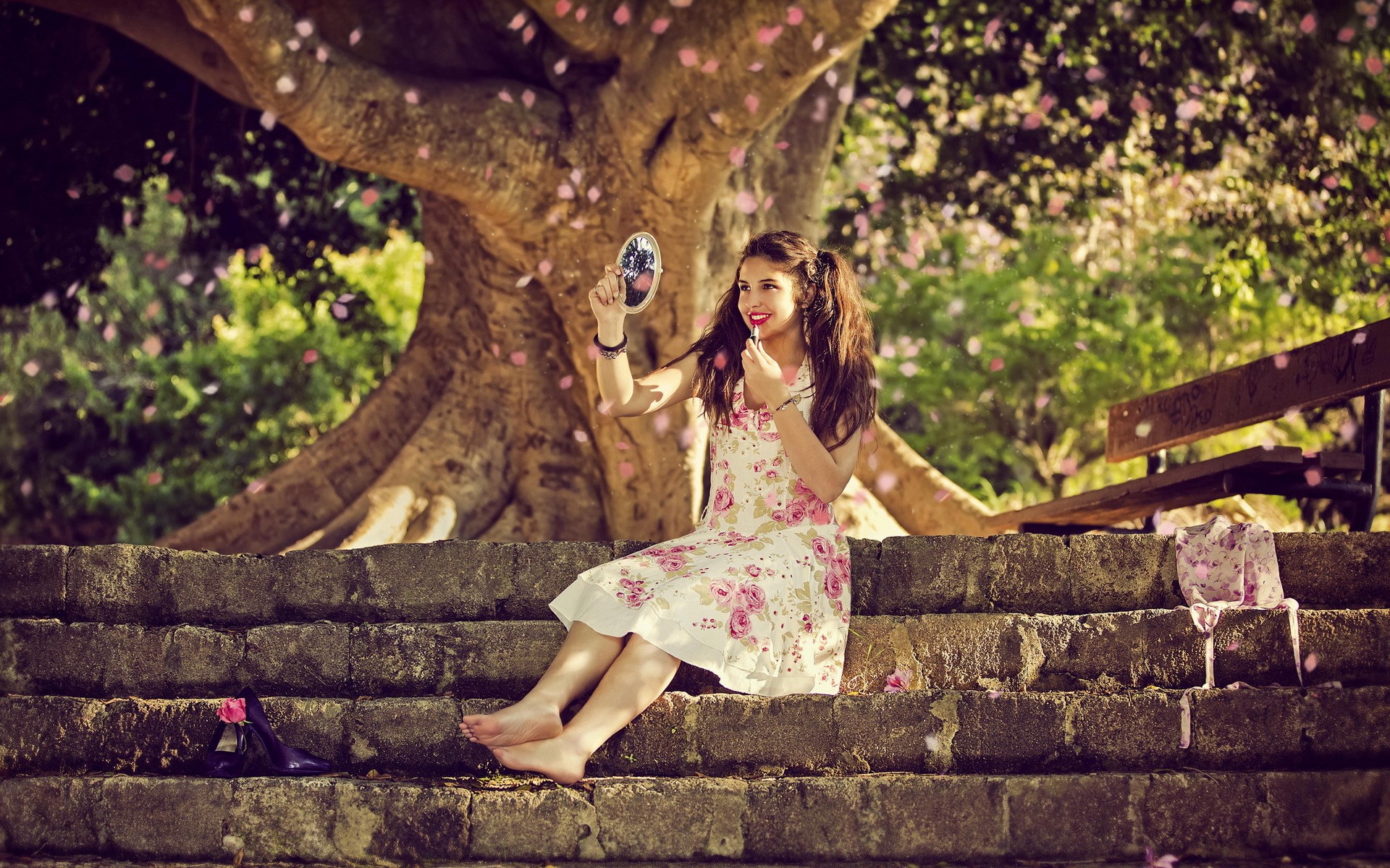 Girl applying makeup under a tree HD Wallpaper