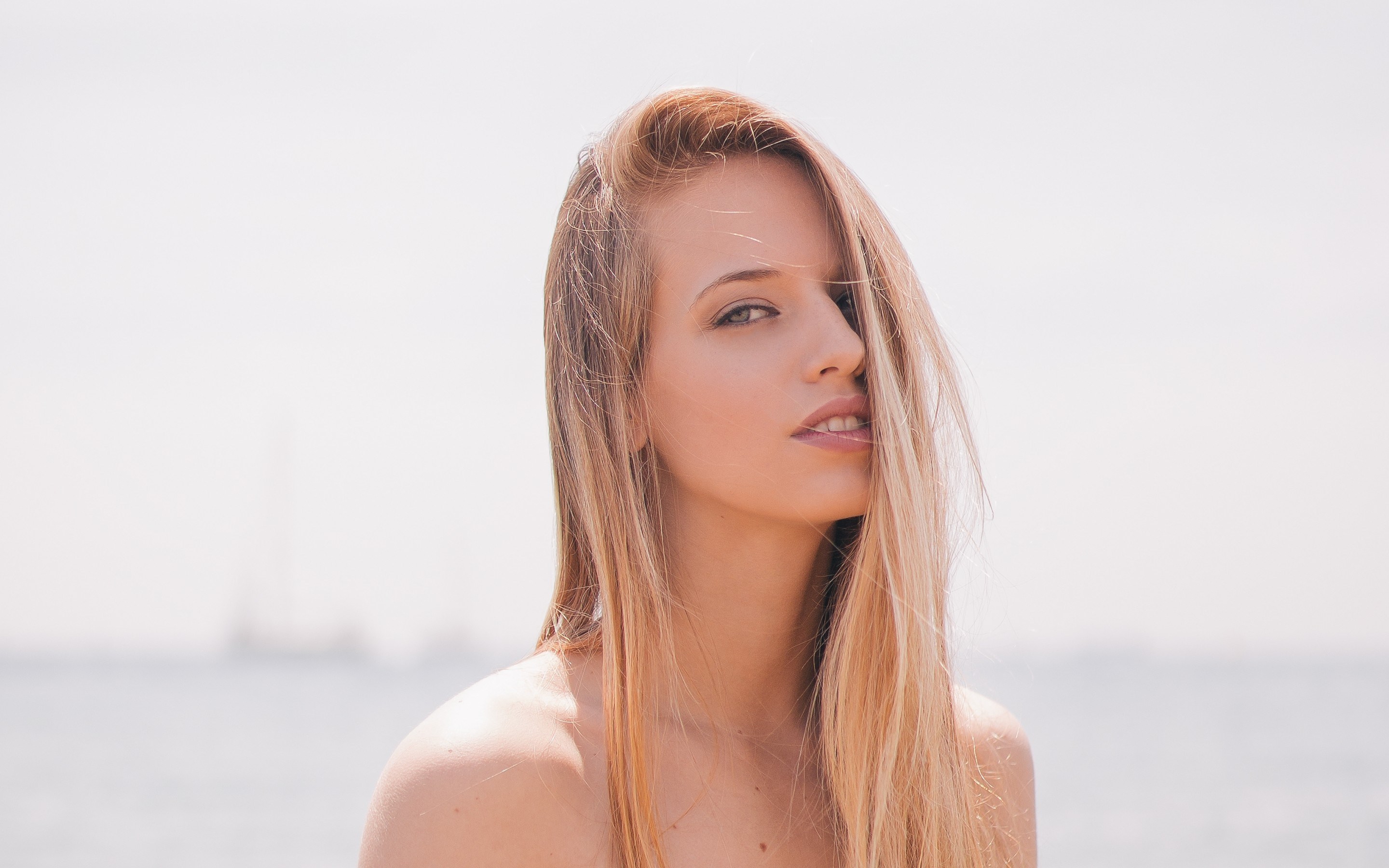 Woman with blonde hair at the beach HD Wallpaper