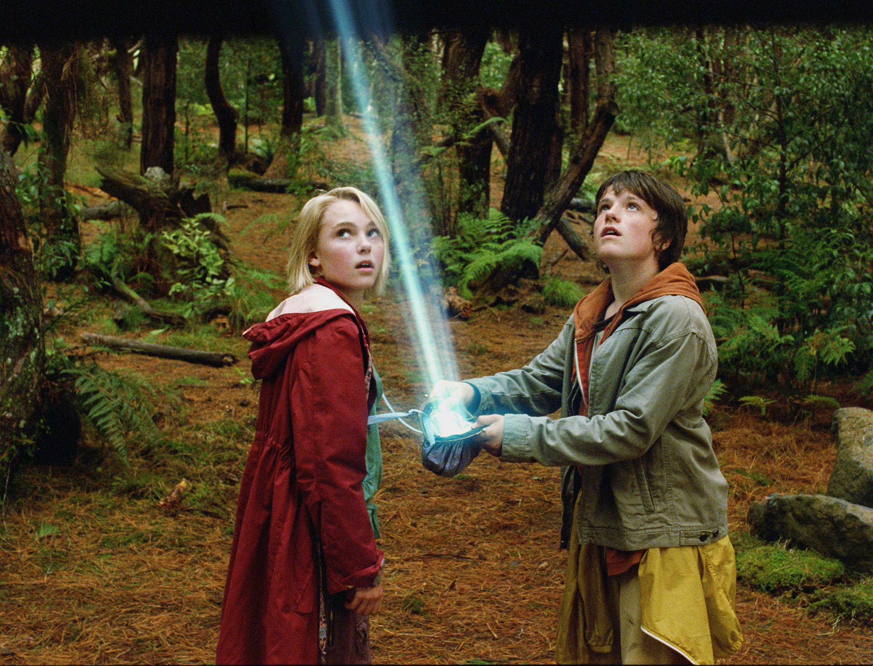 Two children in a forest with a light beam HD Wallpaper