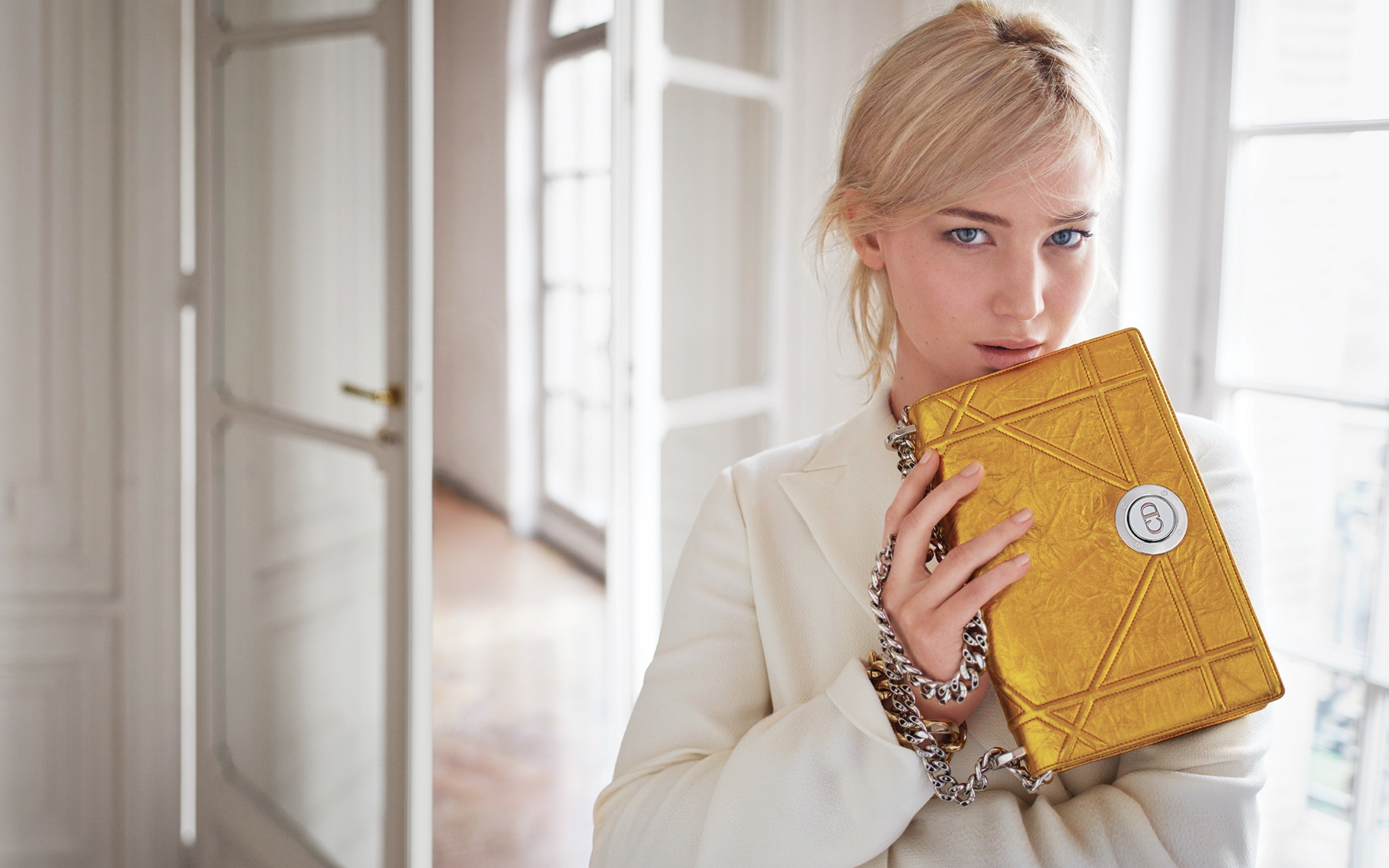 Woman in white blazer holding a gold Dior bag HD Wallpaper