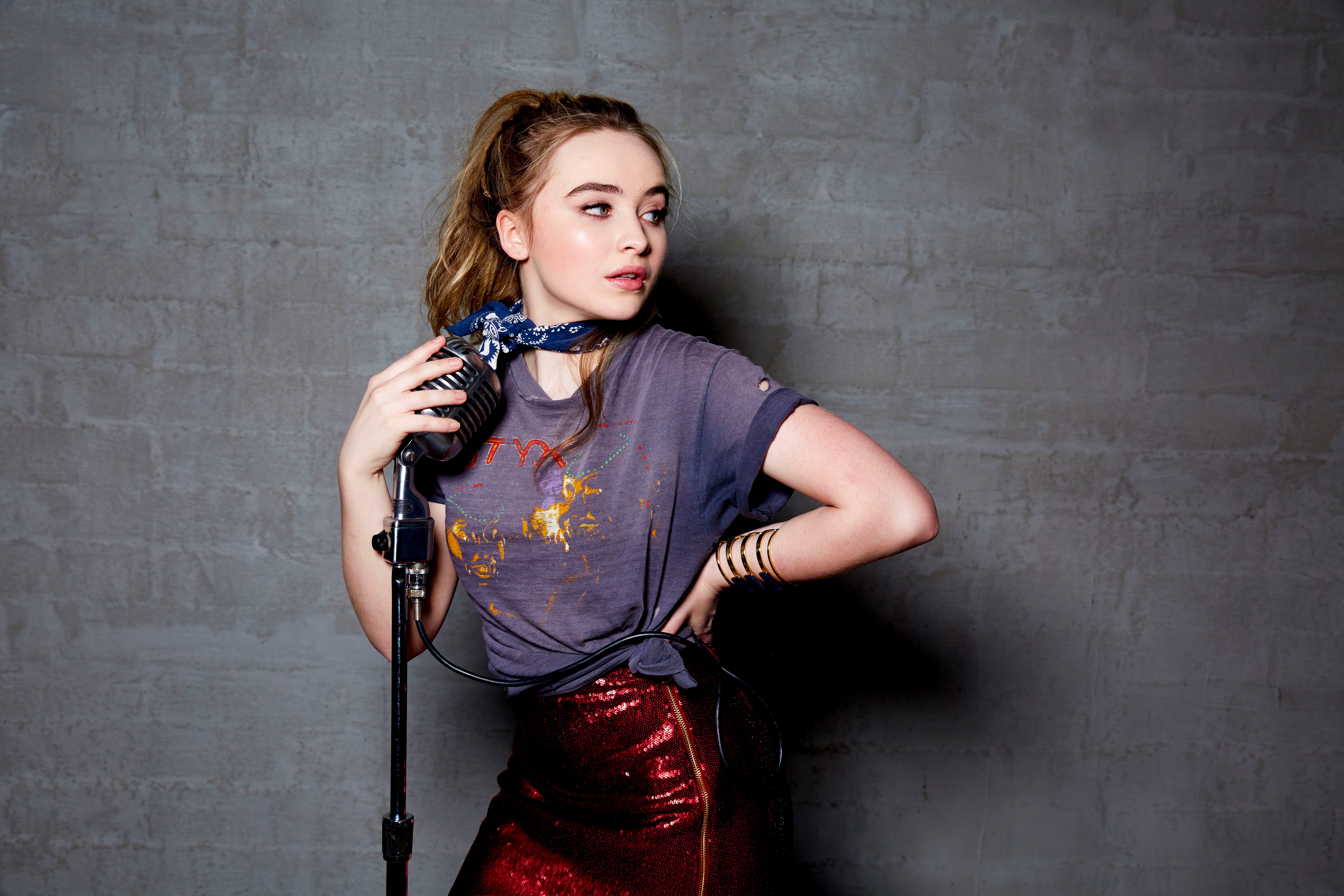Sabrina Carpenter with microphone HD Wallpaper