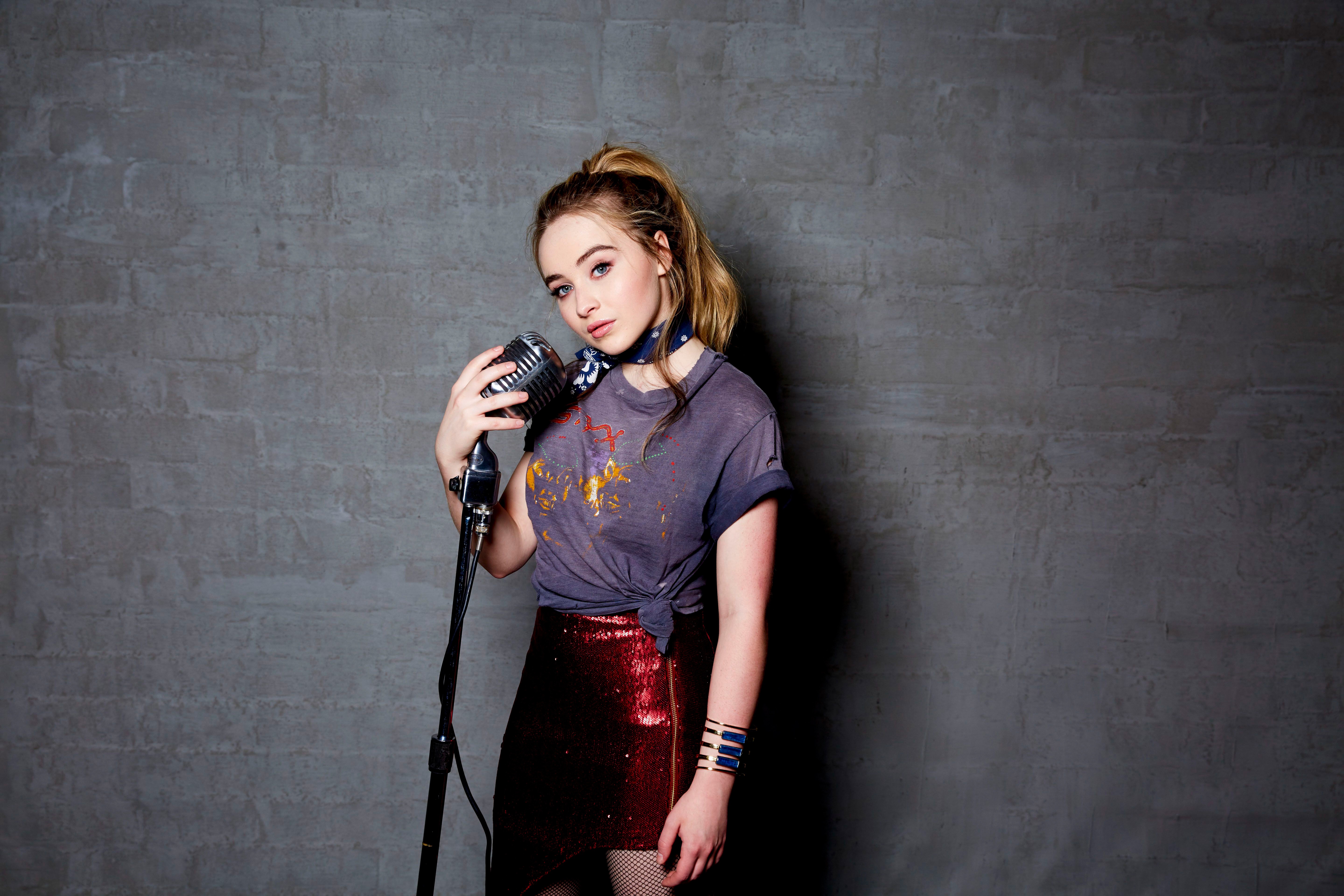 Sabrina Carpenter with microphone HD Wallpaper