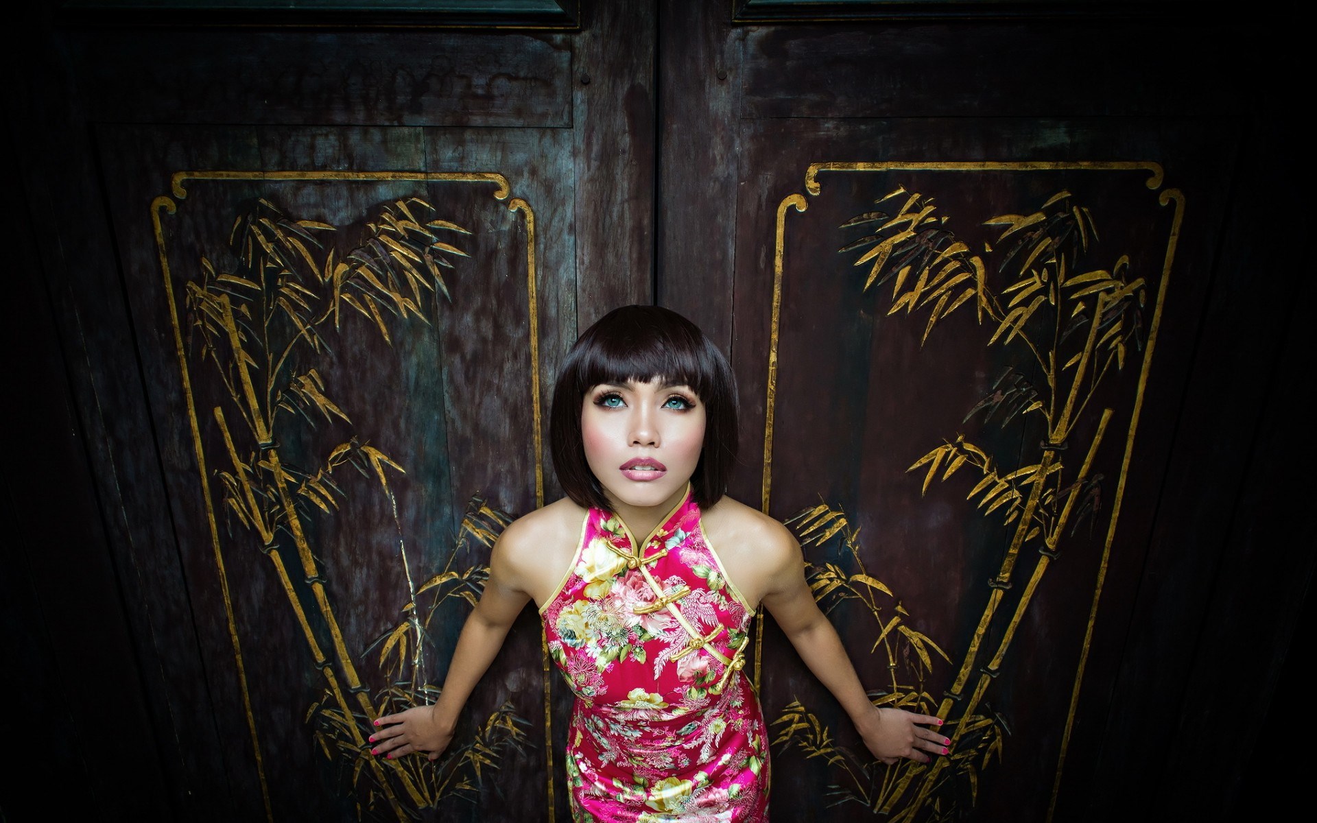 Woman in Cheongsam in front of ornate doors HD Wallpaper