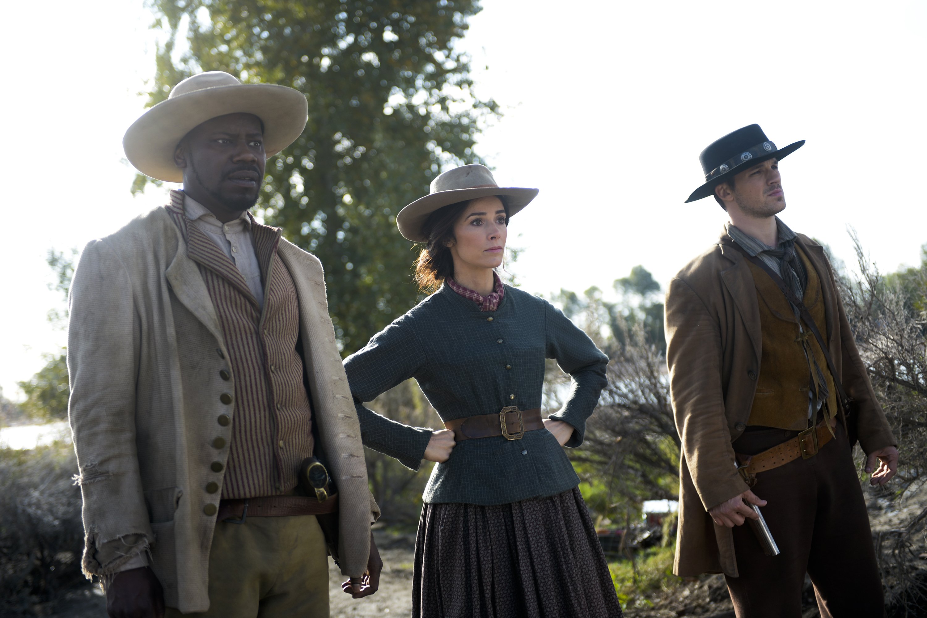 Three people in Western attire outdoors HD Wallpaper