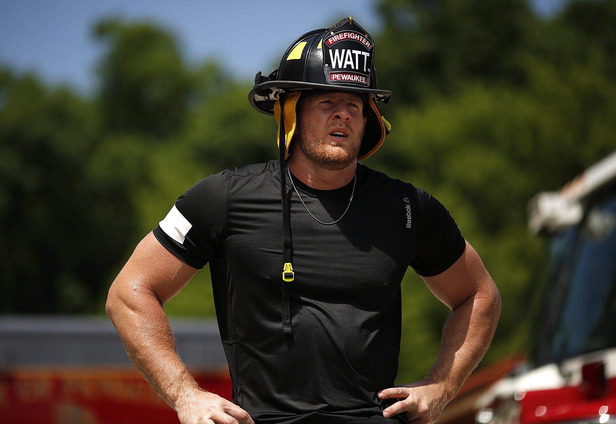 J.J. Watt wearing a firefighter helmet HD Wallpaper
