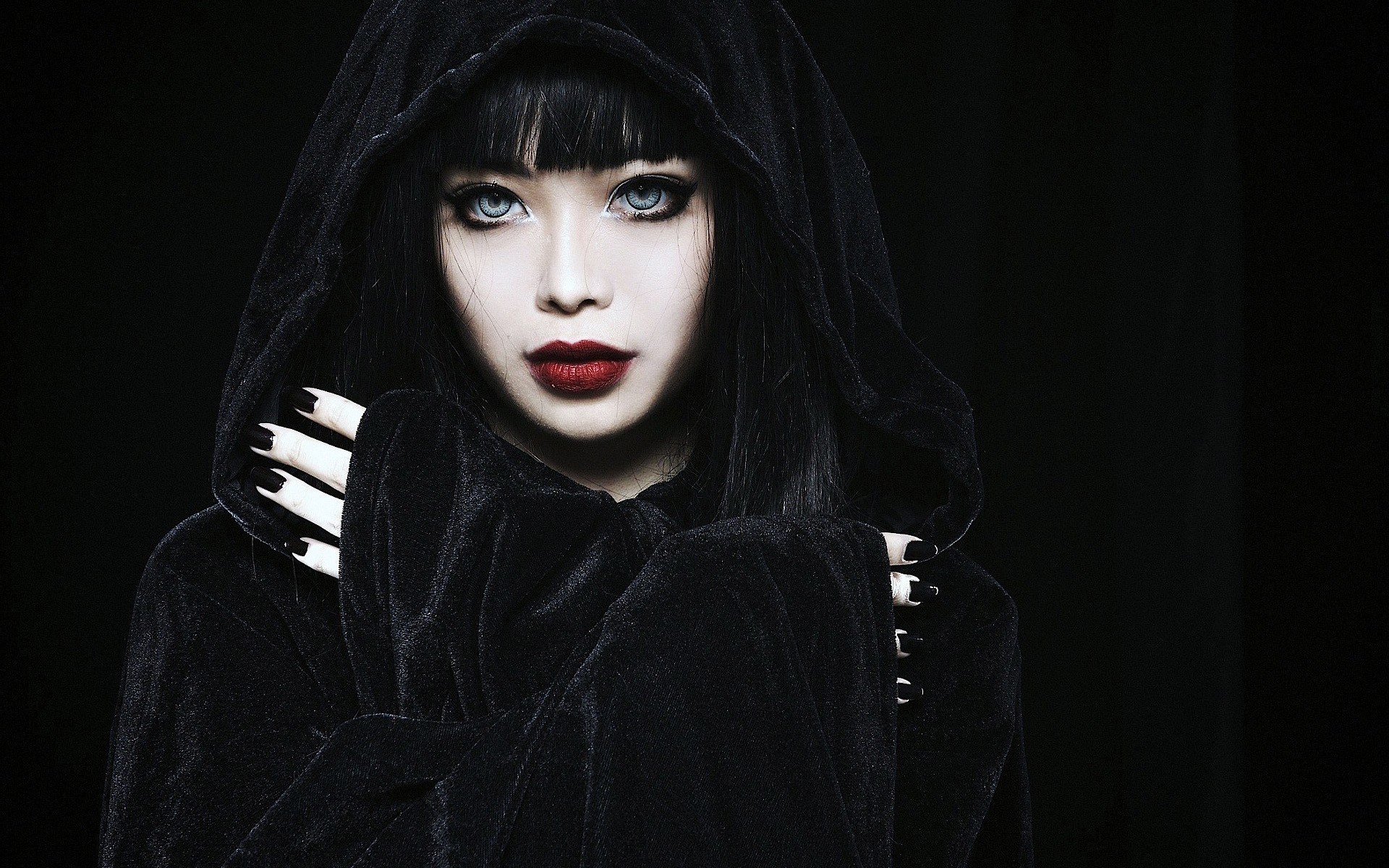 Woman in black hooded robe with striking makeup HD Wallpaper
