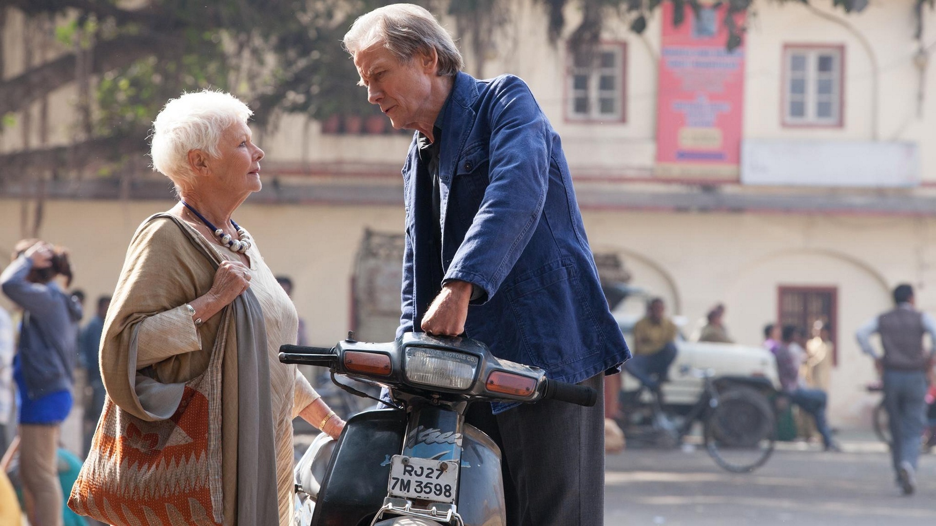 Judi Dench and Bill Nighy on a scooter in India HD Wallpaper