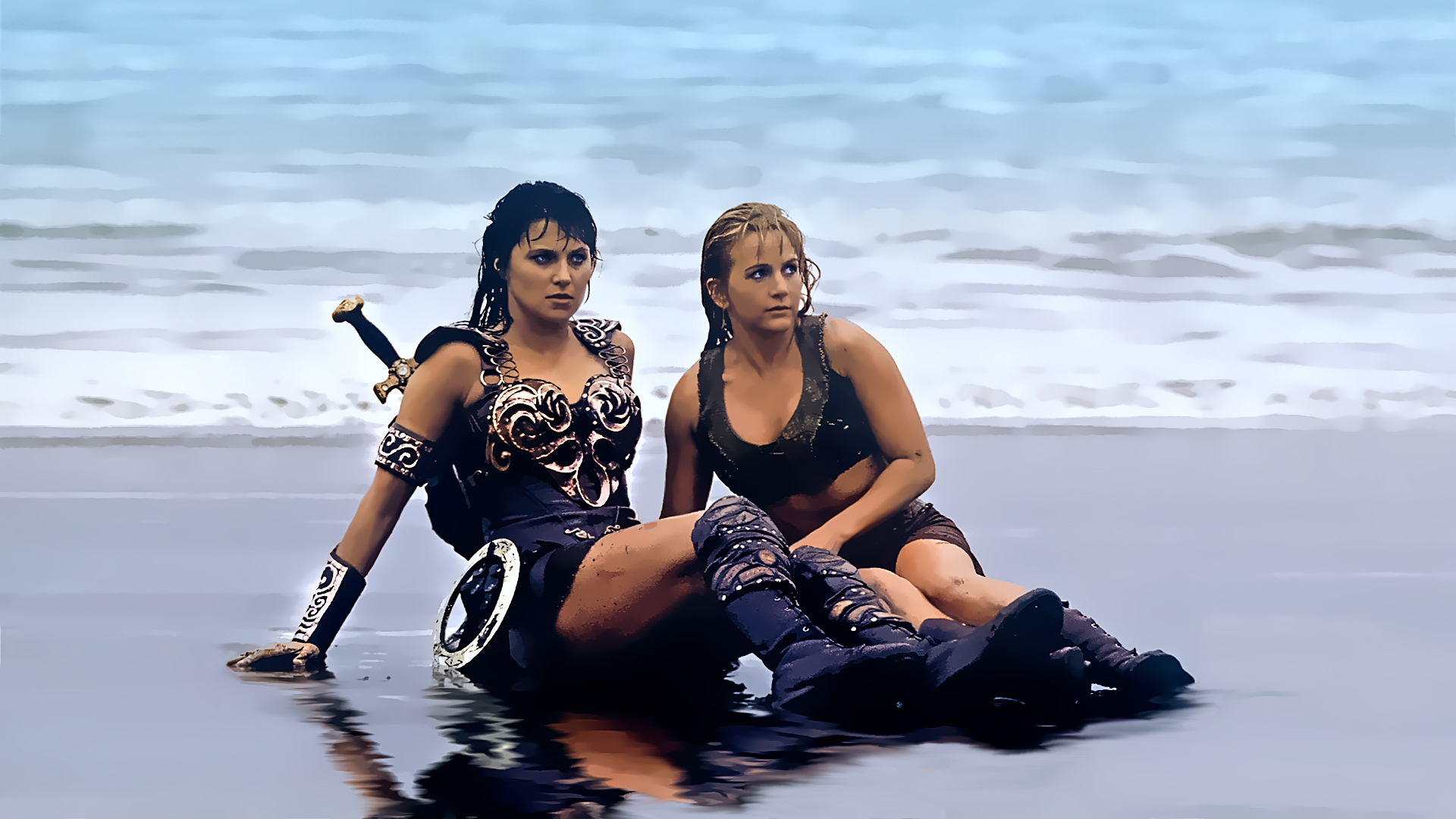 Lucy Lawless and Renee O'Connor on a beach HD Wallpaper