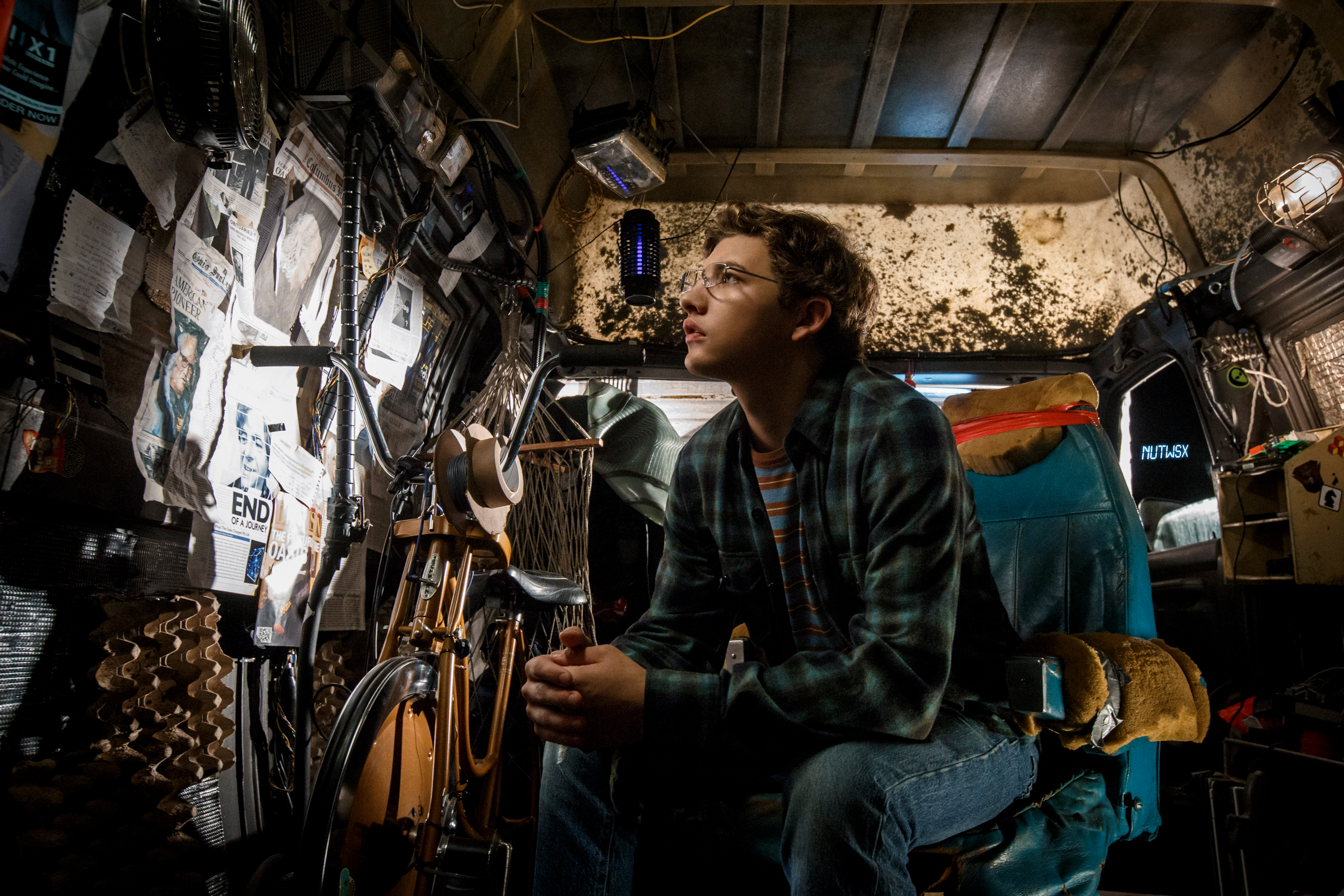 Tye Sheridan in a cluttered room HD Wallpaper