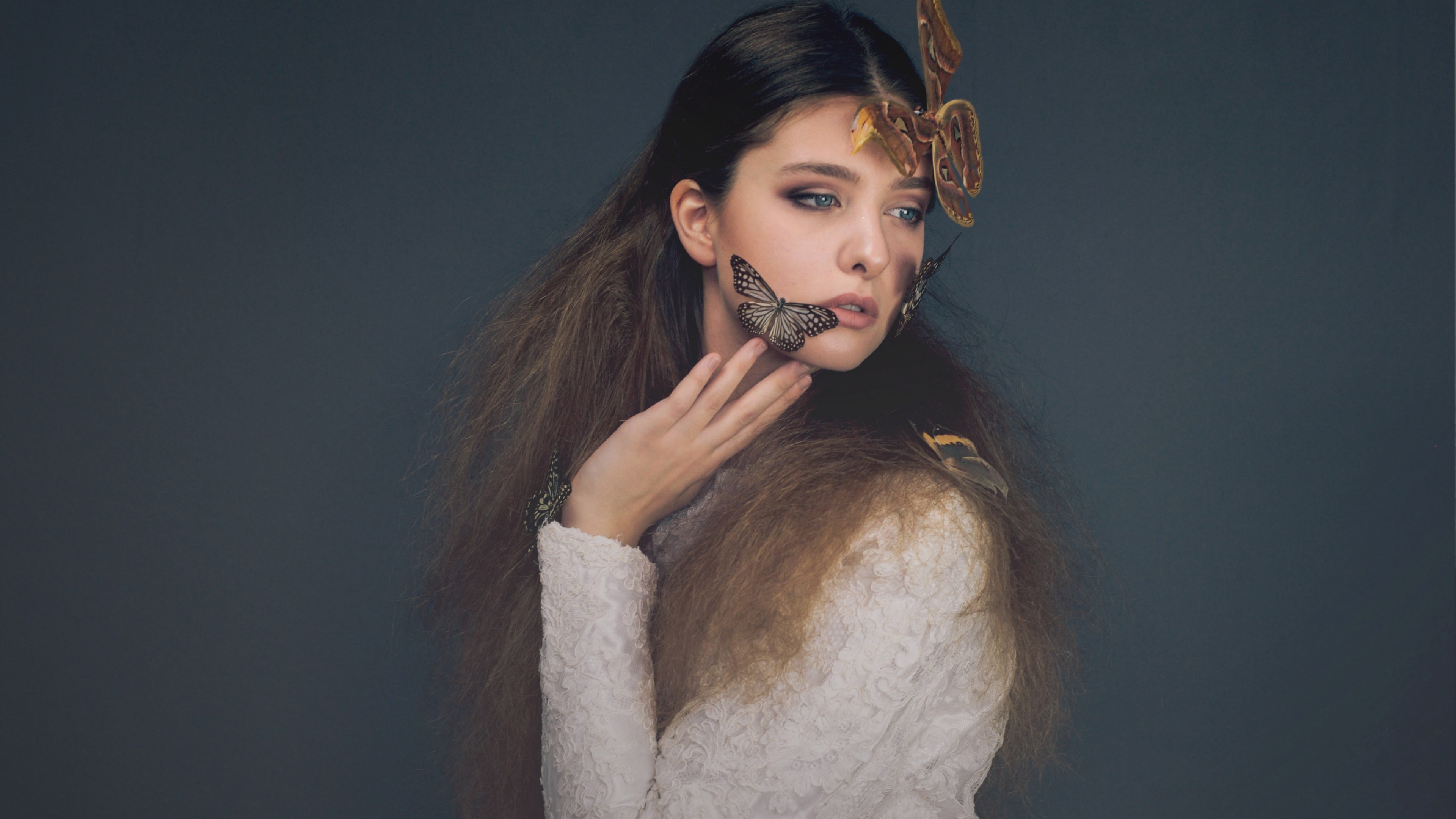 Woman with butterflies on her face and hair HD Wallpaper