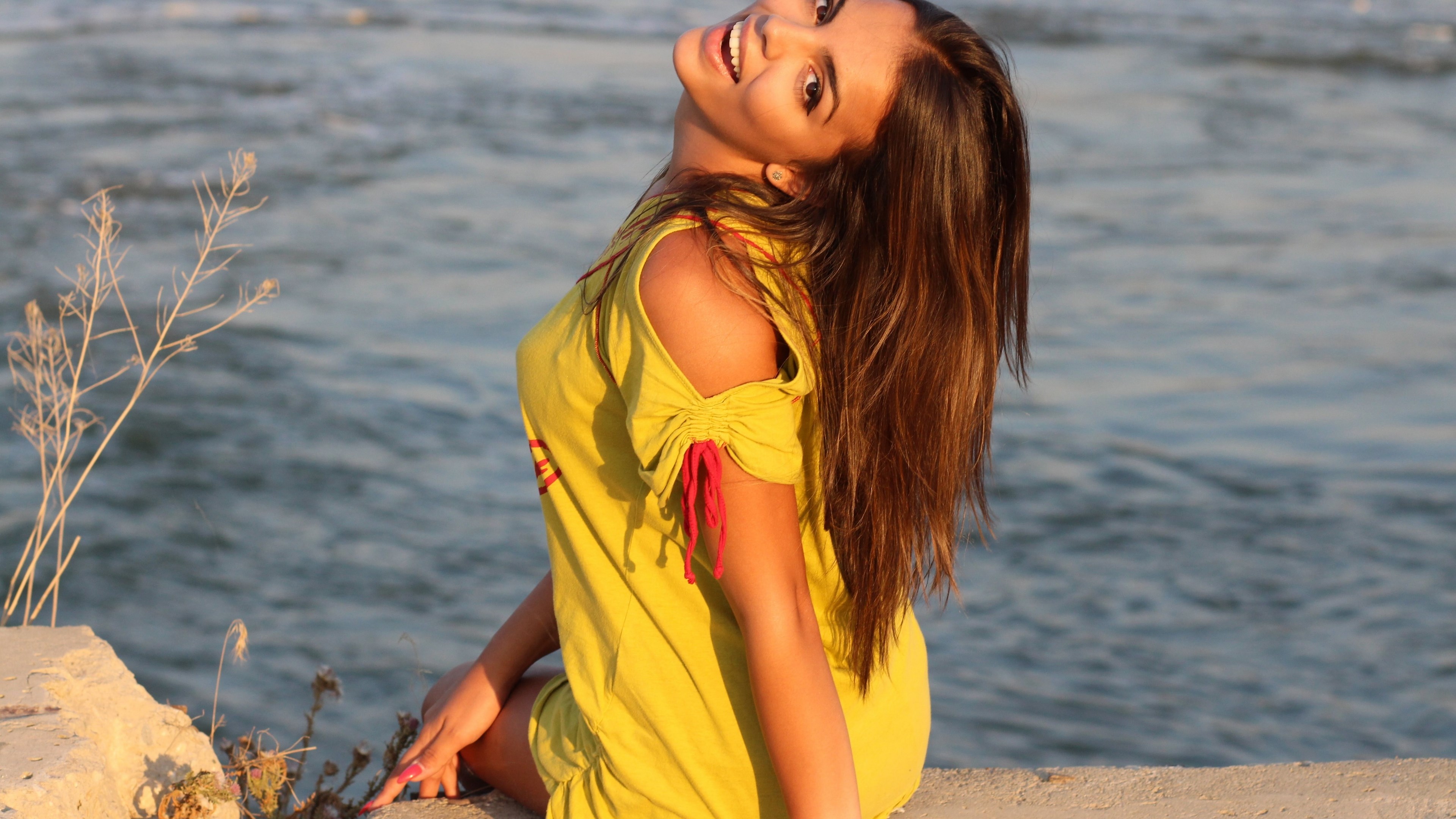 Woman in yellow dress by the water HD Wallpaper